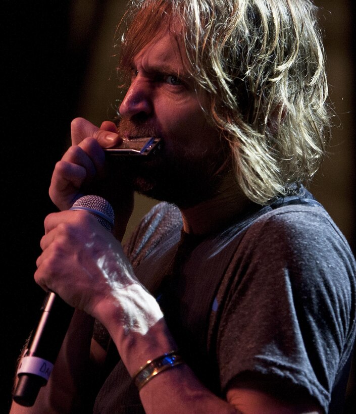 MARINE CORPS BASE HAWAII - Dan Meyers, a vocalist and violinist for the Lt. Dan Band, plays a harmonica on stage during a concert on Marine Corps Base Hawaii, Feb. 22. Actor Gary Sinise, an avid supporter of service members, and the Lt. Dan Band have toured military installations and performed concerts for troops and their families with the United Service Organizations since 2004.