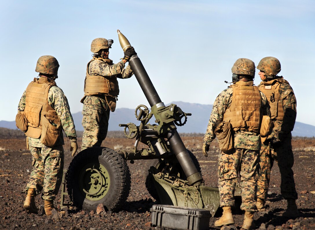 POHAKULOA TRAINING AREA, Hawaii - A field artilleryman with Alpha Battery, 1st Battalion, 12th Marine Regiment, loads the M327 120 mm mortar system by stepping onto a metal crate and dropping ammunition into the barrel during Operation Spartan Fury at Pohakuloa Training Area, Hawaii, Feb. 21, 2013. The Alpha Battery Marines used the mortar system for the first time during the training exercise and were mentored by Marines from Bravo Battery to become familiar with the new weaponry.(U.S. Marine Corps photo by Lance Cpl. Nathan Knapke)