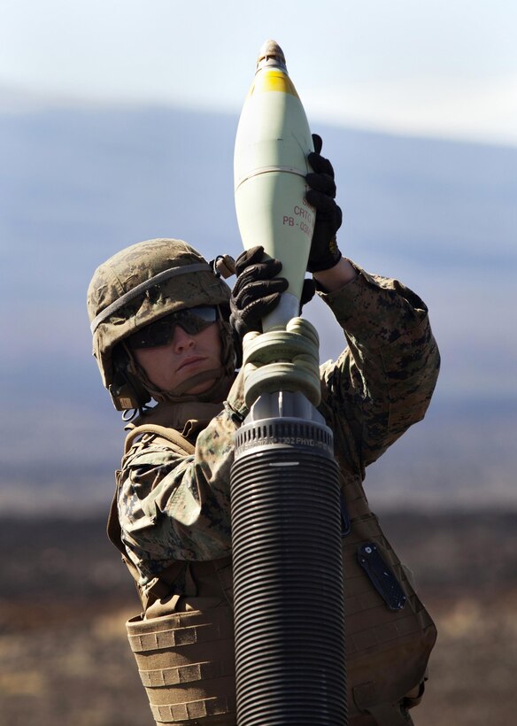 POHAKULOA TRAINING AREA, Hawaii - Lance Cpl. Tyler Carpenter, a field artilleryman with Alpha Battery, 1st Battalion, 12th Marine Regiment, loads the M327 120 mm mortar system by dropping ammunition into the barrel during Operation Spartan Fury at Pohakuloa Training Area, Hawaii, Feb. 21, 2013. The Alpha Battery Marines used the mortar system for the first time during the training exercise and were mentored by Marines from Bravo Battery to become familiar with the new weaponry.(U.S. Marine Corps photo by Lance Cpl. Nathan Knapke)