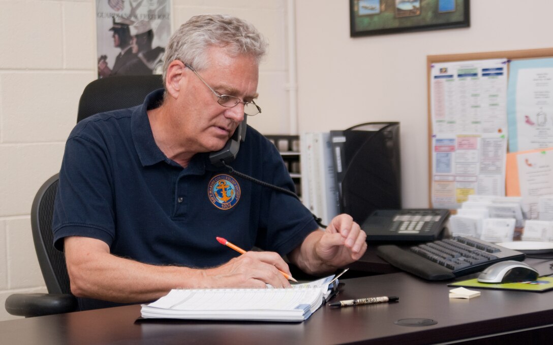 MARINE CORPS BASE HAWAII - Volunteer Mark Van Allsburg answers the phone at the Navy-Marine Corps Relief Society during the organization’s open house, Feb. 21, 2013. The relief society offers Budget for Baby classes, assistance with preparing budgets and financial assistance to eligible military personnel. (U.S. Marine Corps photo by Kristen Wong)
