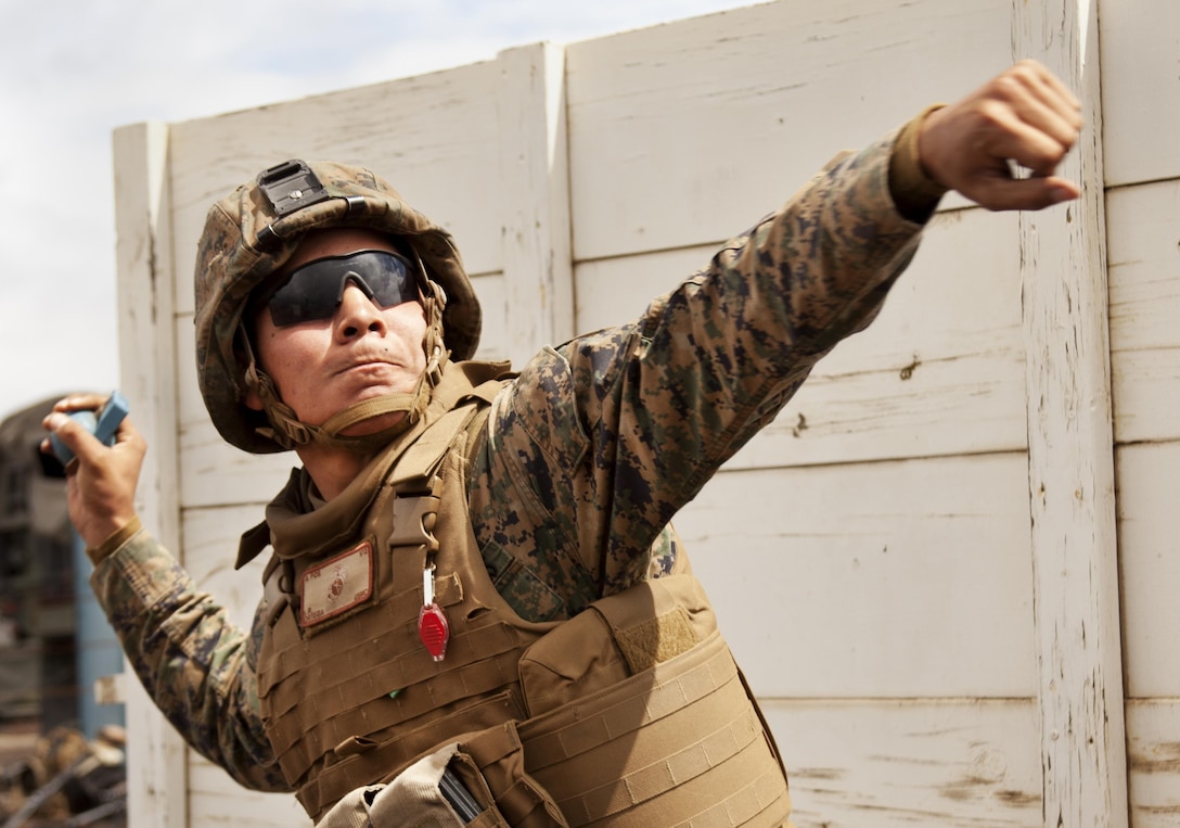 POHAKULOA TRAINING AREA, Hawaii - Lance Cpl. Louie Ortega, a motor vehicle operator with Bravo Battery, 1st Battalion, 12th Marine Regiment and native of Mira Loma, Calif., winds up to throw a simulated grenade during Exercise Spartan Fury at Pohakuloa Training Area on the Island of Hawaii, Feb. 21, 2013. Marines threw several practice grenades to demonstrate their proficiency in the prone, kneeling and standing throwing positions. They later practiced throwing live grenades on a separate range. (U.S. Marine Corps photo by Lance Cpl. Nathan Knapke)
