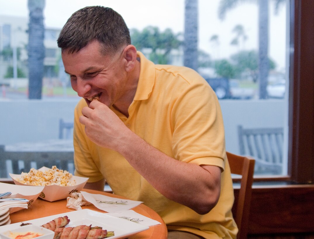 MARINE CORPS BASE HAWAII - Maj. Joe Androski, a senior defense counsel with the Legal Services Support Team at the Legal Services Center, tries an asparagus roll while dining at Club Pub at the Officers’ Club, Feb. 22, 2013. To keep up with current trends, Marine Corps Community Services researched, designed and tested a new menu to be served in the Maui and Kauai Rooms at the Officers’ Club. (U.S. Marine Corps photo by Kristen Wong)