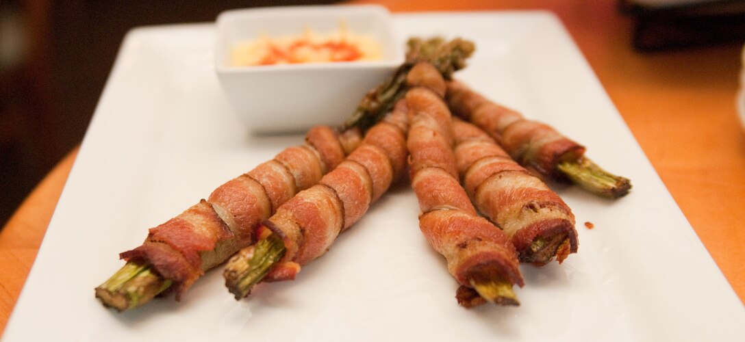 MARINE CORPS BASE HAWAII - The asparagus roll, made of asparagus wrapped in applewood-smoked bacon, is one of the many items offered on the new Club Pub menu at the Officers’ Club. To keep up with current trends, Marine Corps Community Services researched, designed and tested a new menu to be served in the Maui and Kauai Rooms at the Officers’ Club. (U.S. Marine Corps photo by Kristen Wong)
