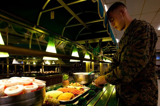 MARINE CORPS BASE HAWAII - Lance Cpl. Alex Bosma, a helicopter mechanic with Marine Aviation Logistics Squadron 24 and native of Seattle, grabs a plate of fruit during breakfast at Anderson Hall Dining Facility, Feb. 27. Bosma, who learned about nutrition as a teen, recommends eating more fruits and vegetables for a healthy diet and to help maintain high physical standards. (U.S. Marine Corps photo by Cpl. James A. Sauter) 