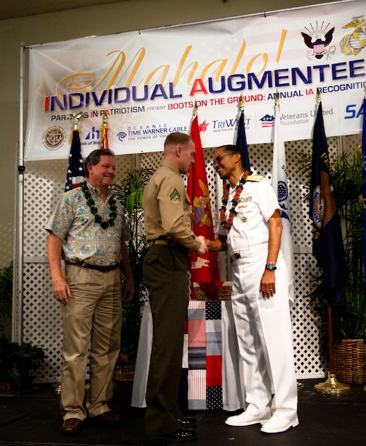 HONOLULU - Cpl. Brandon Jones, a rifleman with 1st Battalion, 3rd Marine Regiment and native of Romeo, N.Y., receives a coin from Adm. Cecil Haney, commander of U.S. Pacific Fleet and native of Washington, D.C., during a Navy League luncheon honoring the service of individual augmentees in support of overseas operations at the Ala Moana Hotel, Feb. 28. The Navy League dedicates itself to providing education programs for the American people on the U.S.’ role as a maritime power and the economic importance of free and open sea-lanes. (U.S. Marine Corps photo by Cpl. James A. Sauter) 