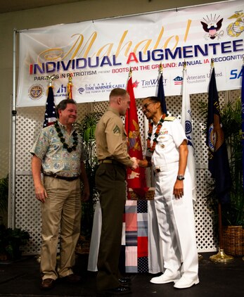 HONOLULU - Cpl. Brandon Jones, a rifleman with 1st Battalion, 3rd Marine Regiment and native of Romeo, N.Y., receives a coin from Adm. Cecil Haney, commander of U.S. Pacific Fleet and native of Washington, D.C., during a Navy League luncheon honoring the service of individual augmentees in support of overseas operations at the Ala Moana Hotel, Feb. 28. The Navy League dedicates itself to providing education programs for the American people on the U.S.’ role as a maritime power and the economic importance of free and open sea-lanes. (U.S. Marine Corps photo by Cpl. James A. Sauter) 

