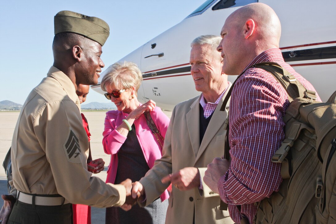 Gen. James F. Amos, commandant of the Marine Corps, presents Sgt. Rousseau Saintilfort, the awards noncommissioned officer in charge, Marine Wing Headquarters Squadron 3, 3rd Marine Aircraft Wing, and a Brooklyn, N.Y., native, with a Commandant’s challenge coin aboard Marine Corps Air Station Miramar, Calif., March 1. The Commandant and Sgt. Maj. Micheal P. Barrett, Sgt. Maj. of the Marine Corps, right, congratulated Saintilfort for his efforts in arranging a morning colors ceremony, Feb. 22, aboard MCAS Miramar. The colors ceremony was held to honor Black History Month and the efforts of the Tuskegee Airmen and is first monthly colors ceremony to feature a sergeant as the reviewing officer. It was the first event of Maj. Gen. Steven Busby’s, the commanding general of 3rd Marine Aircraft Wing, initiative coined “Committed and Engaged Leadership,” which will include empowering NCOs.


