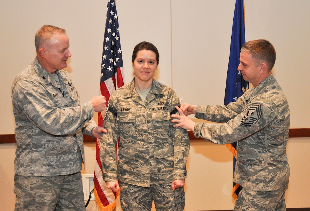 Master Sgt. Jill LaVoie, 460th Space Wing Public Affairs superintendent, gets her newest stripes “tacked on” by Col. Dan Dant, 460th SW commander, and Chief Master Sgt. William Ward, 460th SW command chief, during a promotion release party Feb. 28, 2013, at the Leadership Development Center on Buckley Air Force Base, Colo. LaVoie is one of six Team Buckley senior master sergeants selects. (U.S Air Force photo by Staff Sgt. Nicholas Rau/Released)  