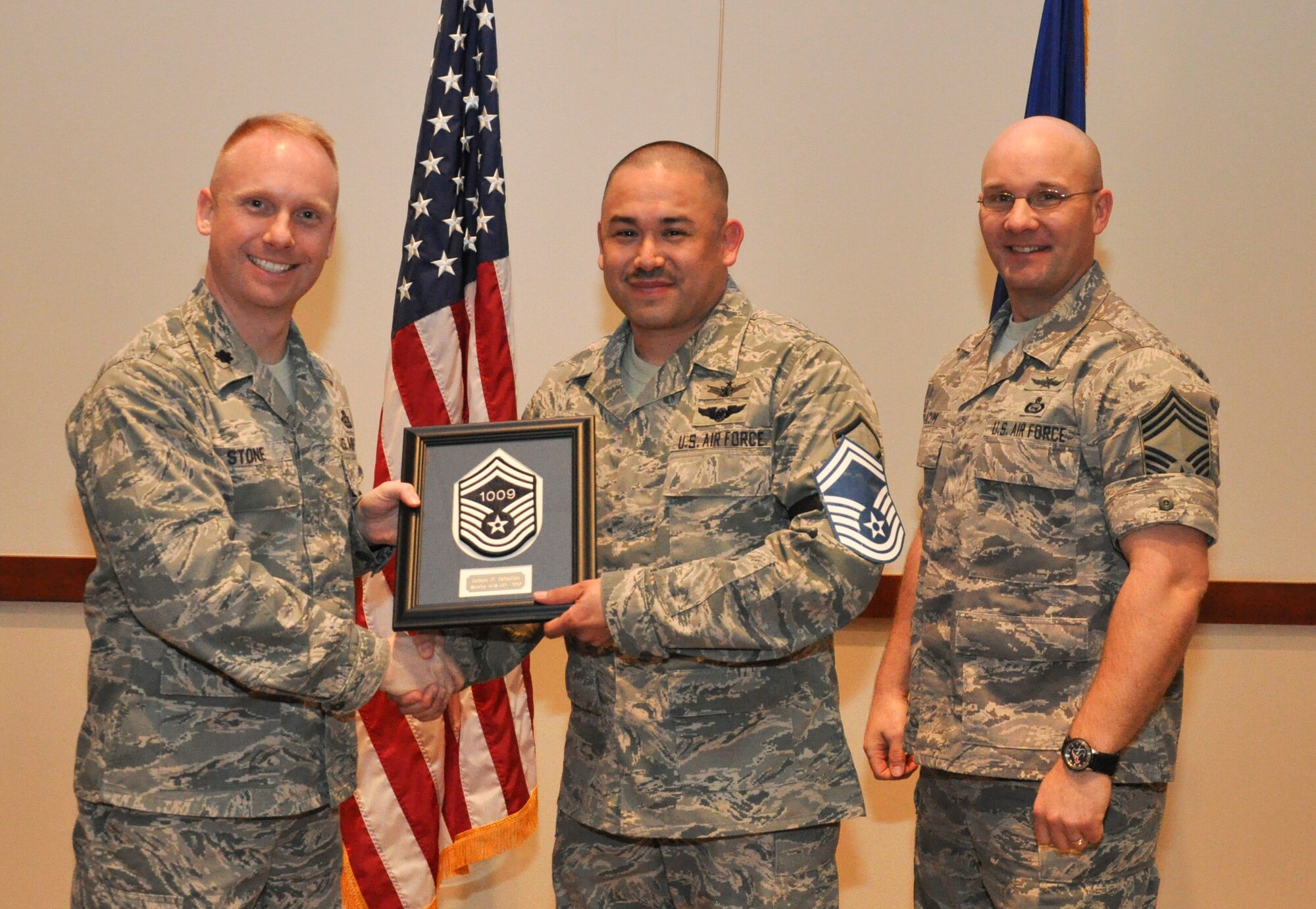Master Sgt. James Seballes, 566th Intelligence Squadron, is recognized for promotion selection by Lt. Col. Adam Stone, 566th IS commander, and Chief Master Sgt. Edward Slacum, 566th IS superintendent, during a promotion release party Feb. 28, 2013, at the Leadership Development Center on Buckley Air Force Base, Colo. Seballes is one of six Team Buckley senior master sergeants selects. (U.S Air Force photo by Staff Sgt. Nicholas Rau/Released)