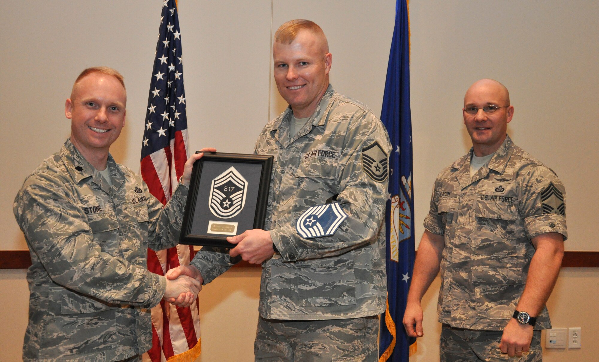 Master Sgt. Robert Rogers, 566th Intelligence Squadron, is recognized for promotion selection by Lt. Col. Adam Stone, 566th IS commander, and Chief Master Sgt. Edward Slacum, 566th IS superintendent, during a promotion release party Feb. 28, 2013, at the Leadership Development Center on Buckley Air Force Base, Colo. Rogers is one of six Team Buckley senior master sergeants selects. (U.S Air Force photo by Staff Sgt. Nicholas Rau/Released)