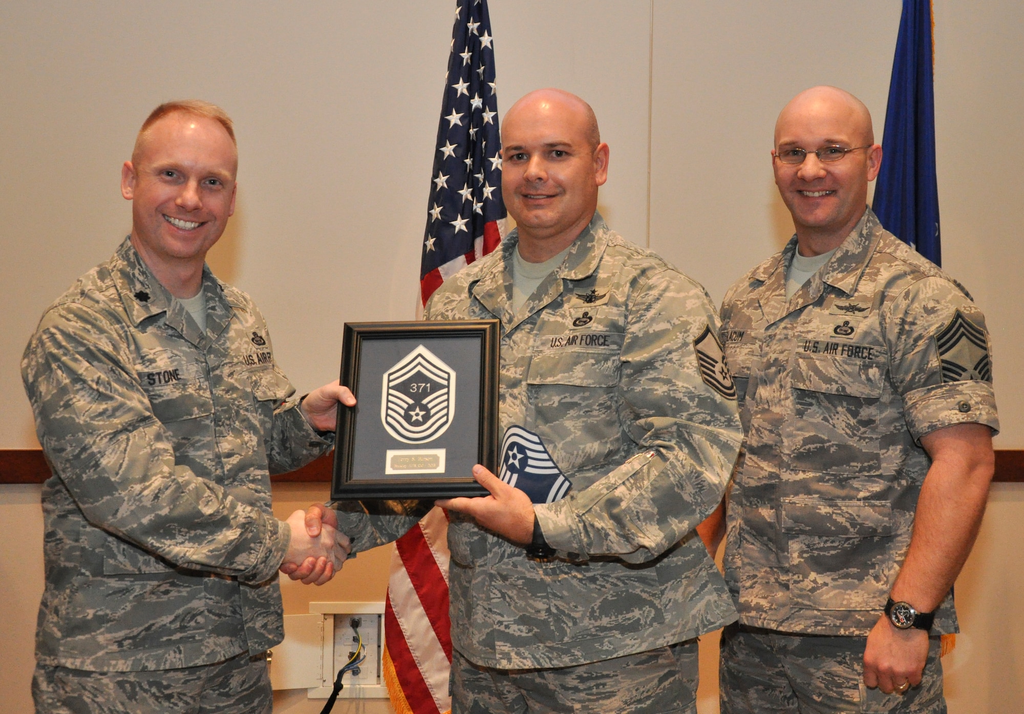 Master Sgt. Terry Burson, 566th Intelligence Squadron, is recognized for promotion selection by Lt. Col. Adam Stone, 566th IS commander, and Chief Master Sgt. Edward Slacum, 566th IS superintendent, during a promotion release party Feb. 28, 2013, at the Leadership Development Center on Buckley Air Force Base, Colo. Burson is one of six Team Buckley senior master sergeants selects. (U.S Air Force photo by Staff Sgt. Nicholas Rau/Released)
