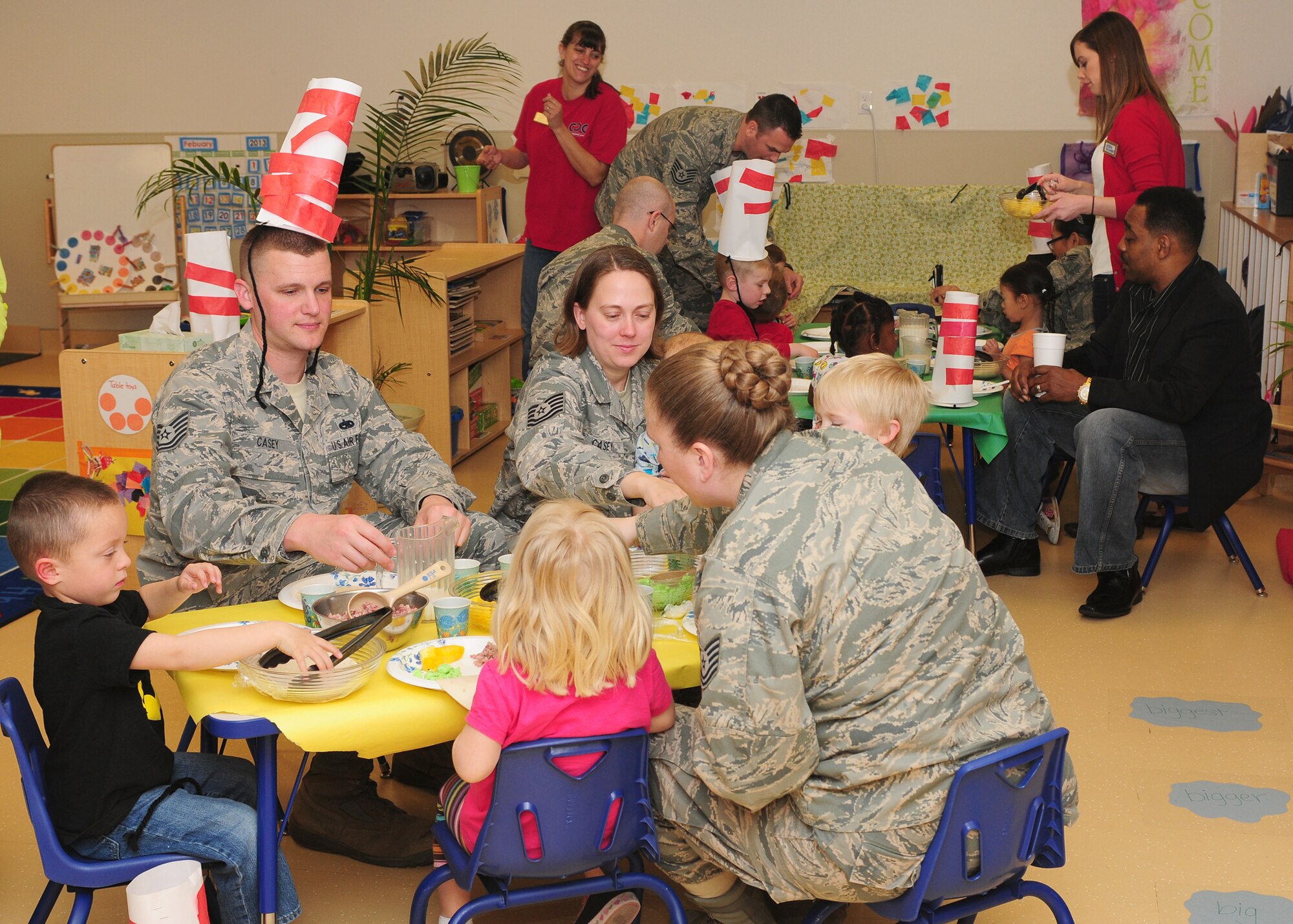 The Child Development Center staff celebrates Dr. Seuss's birthday by hosting a green eggs and ham breakfast at the CDC on Beale Air Force Base Calif., March 1, 2013. The children created Cat in the Hat hats to wear during the event. (U.S. Air Force photo by Senior Airman Allen Pollard/Released)