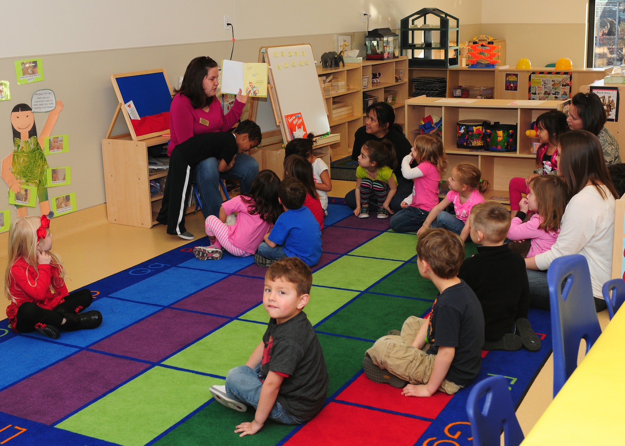 Child Development Center staff and parents read Dr. Seuss books to the children at the CDC on Beale Air Force Base Calif., March 1, 2013. Theodor Seuss Geisel or Dr. Seuss was born in Springfield, Mass. on March 2, 1904, and his birthday has been adopted as National Read Across America Day. (U.S. Air Force photo by Senior Airman Allen Pollard/Released)
