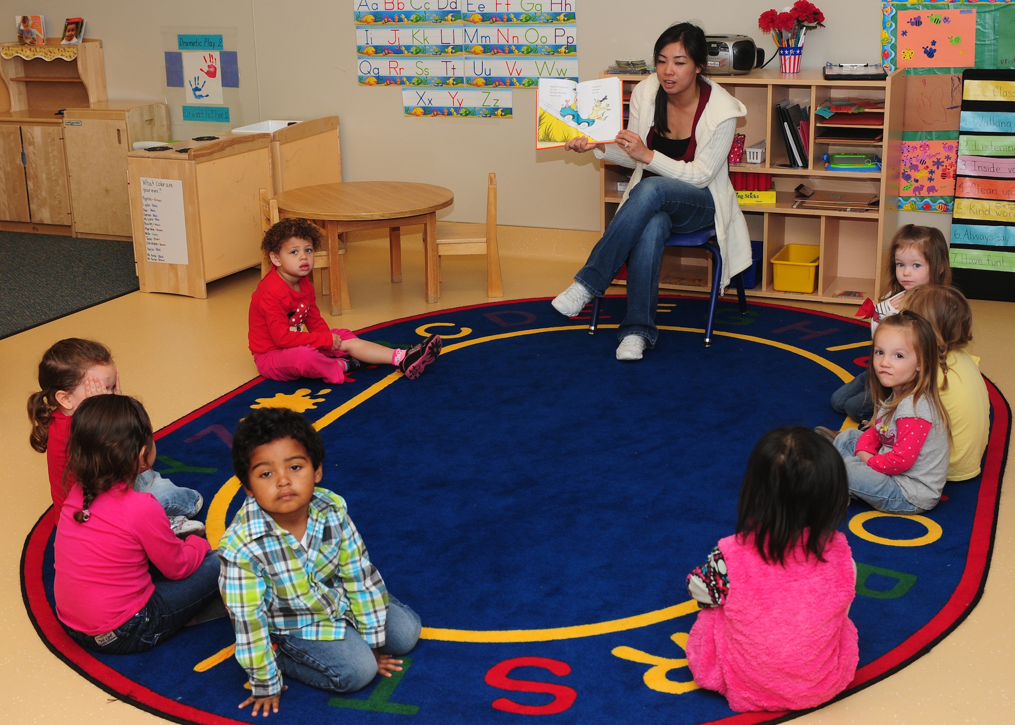 Child Development Center staff and parents read Dr. Seuss books to the children at the CDC on Beale Air Force Base Calif., March 1, 2013. Team Beale parents joined their children for a Green Eggs and Ham breakfast celebrating Dr. Seuss's birthday. (U.S. Air Force photo by Senior Airman Allen Pollard/Released)