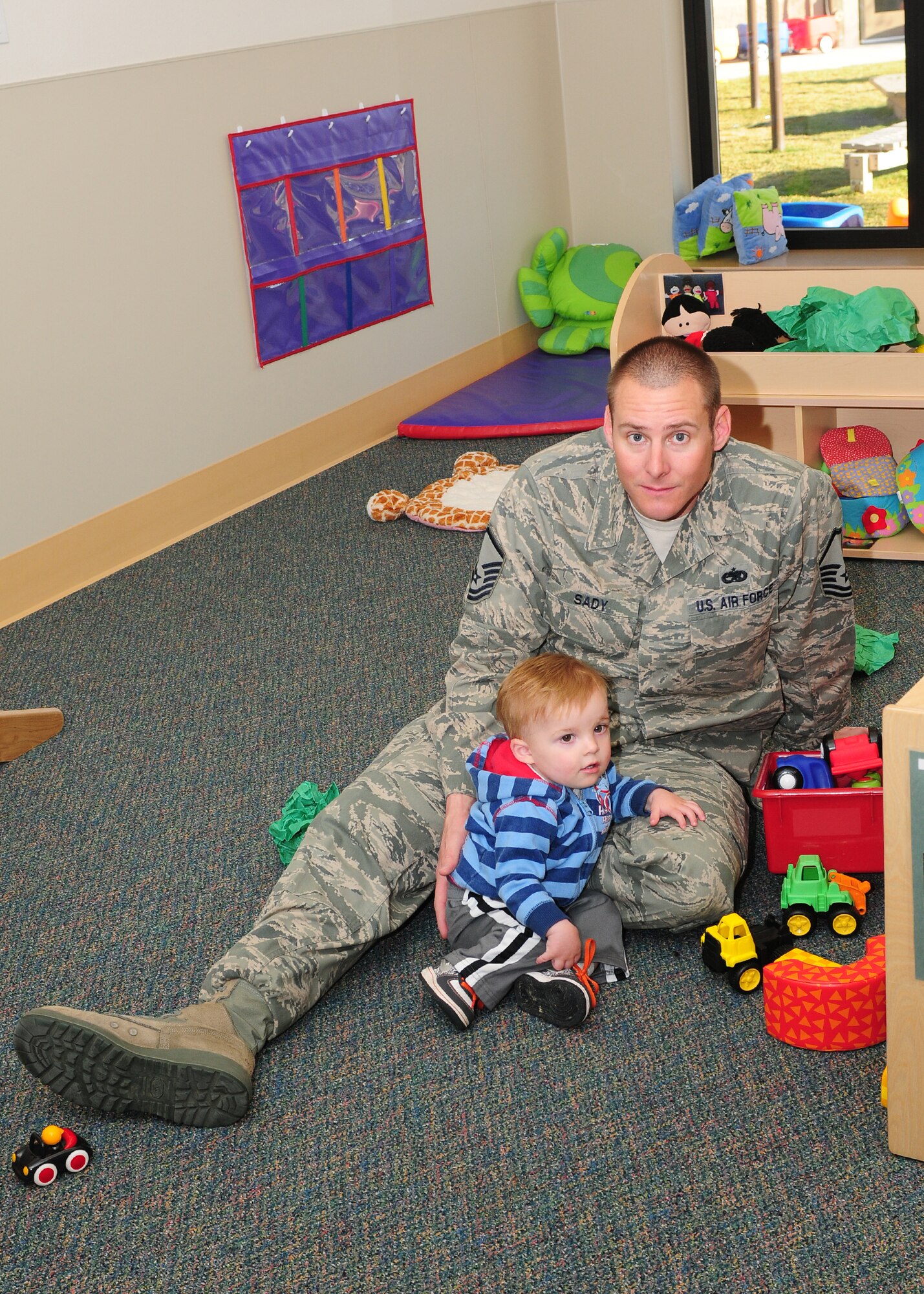 Master Sgt. Nicholas Sady, 9th Munitions Squadron, sits with his son during the Green Eggs and Ham breakfast at the Child Development Center on Beale Air Force Base Calif., March 1, 2013. Sady as well as other Team Beale parents attended the event celebrating Dr. Seuss's birthday.  (U.S. Air Force photo by Senior Airman Allen Pollard/Released)