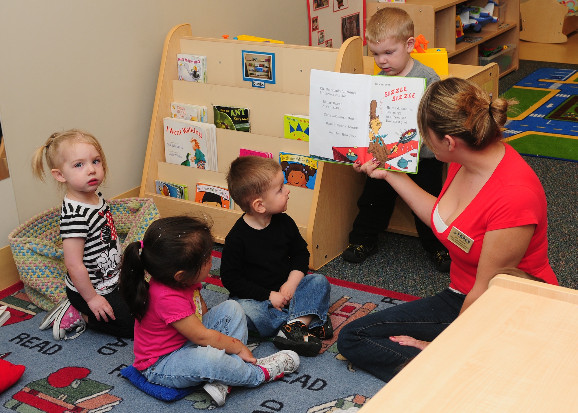 Child Development Center staff celebrates Dr. Seuss's birthday by hosting a Green Eggs and Ham breakfast and reading Dr. Seuss books to the children at the CDC on Beale Air Force Base Calif., March 1, 2013. Four movies have been created based off Dr. Seuss books; "How the Grinch Stole Christmas," "The Cat in the Hat," "Horton Hears a Who!," and "The Lorax." (U.S. Air Force photo by Senior Airman Allen Pollard/Released)