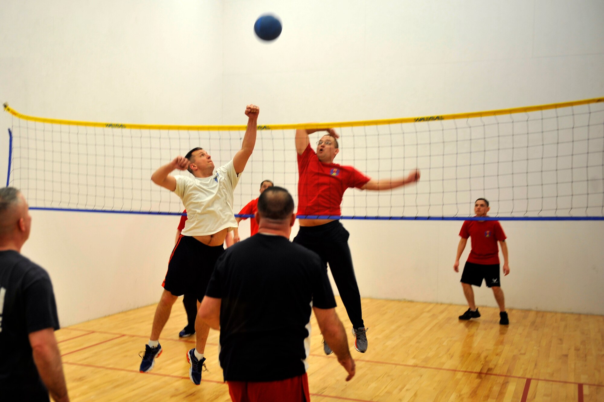 Bradley Moses, Buckley First Sergeants Wallyball Team, spikes on an opponent at the Buckley Wallyball Tournament Feb. 28, 2013, at the fitness center, Buckley Air Force Base, Colo. Eight teams of four to six players competed in a double-elimination style tournament. (U.S. Air Force photo by Airman 1st Class Riley Johnson/Released)
