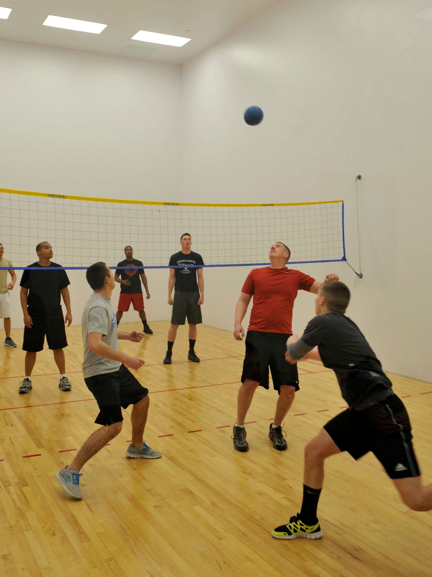 The 460th Force Support Squadron Wallyball Team members volley the ball to the opposing team at the Buckley Wallyball Tournament Feb. 28, 2013, at the fitness center, Buckley Air Force Base, Colo. Eight teams of four to six players competed in a double-elimination style tournament. (U.S. Air Force photo by Airman 1st Class Riley Johnson/Released)