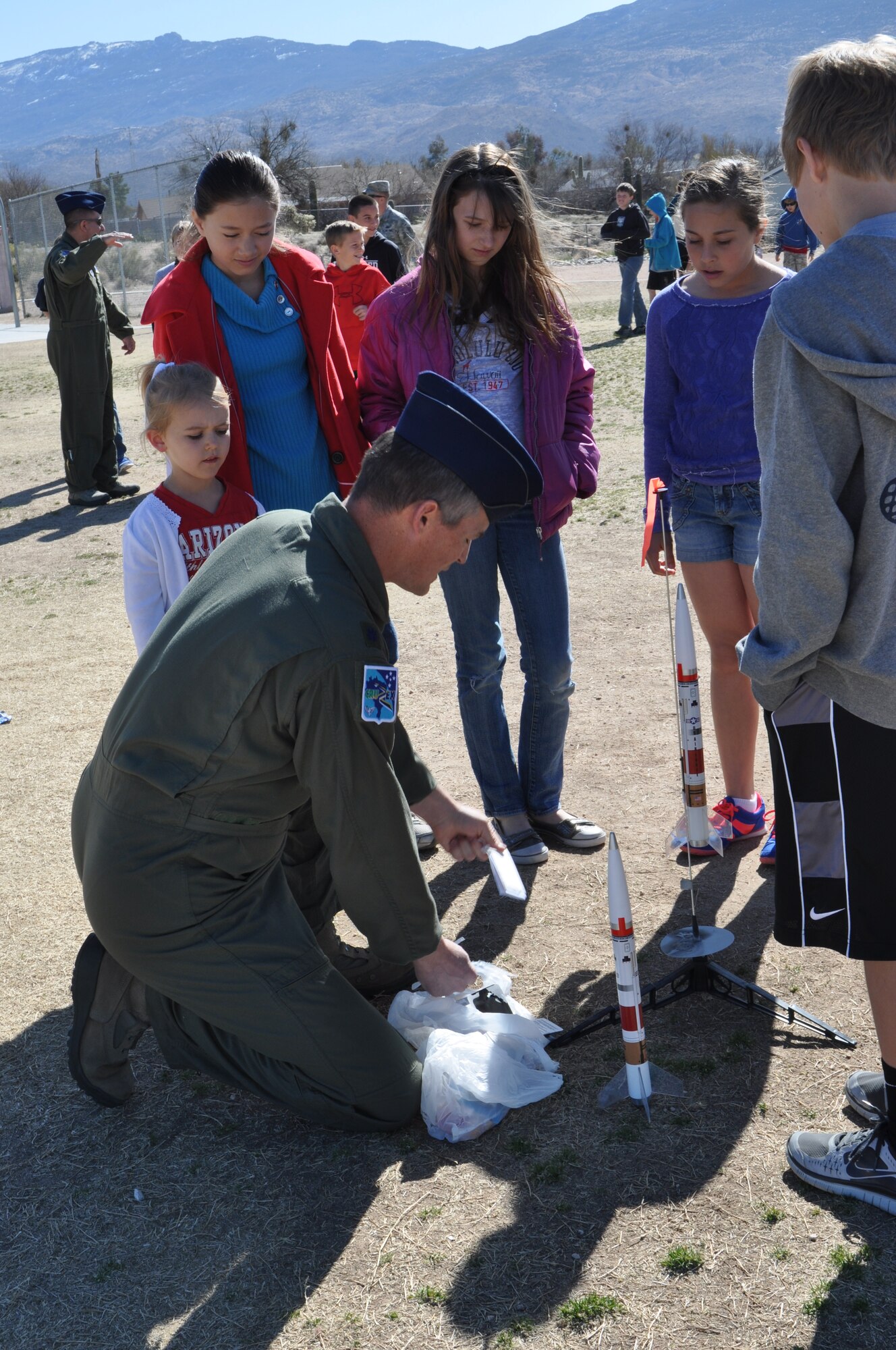 Lt. Col. Dan Jones, 612th Air and Space Operations Center Space Director, prepares to shoot-off a rocket during a demonstration at Tanque Verde Elementary School in Tucson, Ariz., March 1. Airmen from 12th Air Force (Air Forces Southern) gave 5th grade students a lesson on space operations (launch operations, weather support, launch control centers and the importance of launch observation and recovery) during their visit. (USAF photo by Master Sgt. Kelly Ogden/Released).
