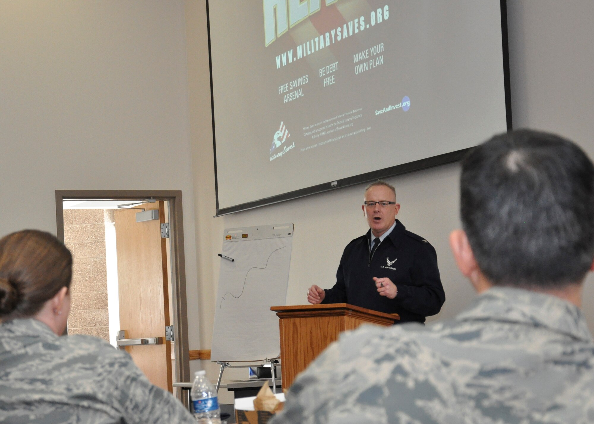 Col. Dan Dant, 460th Space Wing commander, gives closing comments during a financial symposium March 1, 2013, at Bldg. 606, Buckley Air Force Base, Colo. Team Buckley members had the chance to sit in on various financial seminars, where investing, dumping debt and consumer smarts were some of the topics covered. (U.S. Air Force photo by Senior Airman Christopher Gross/Released)