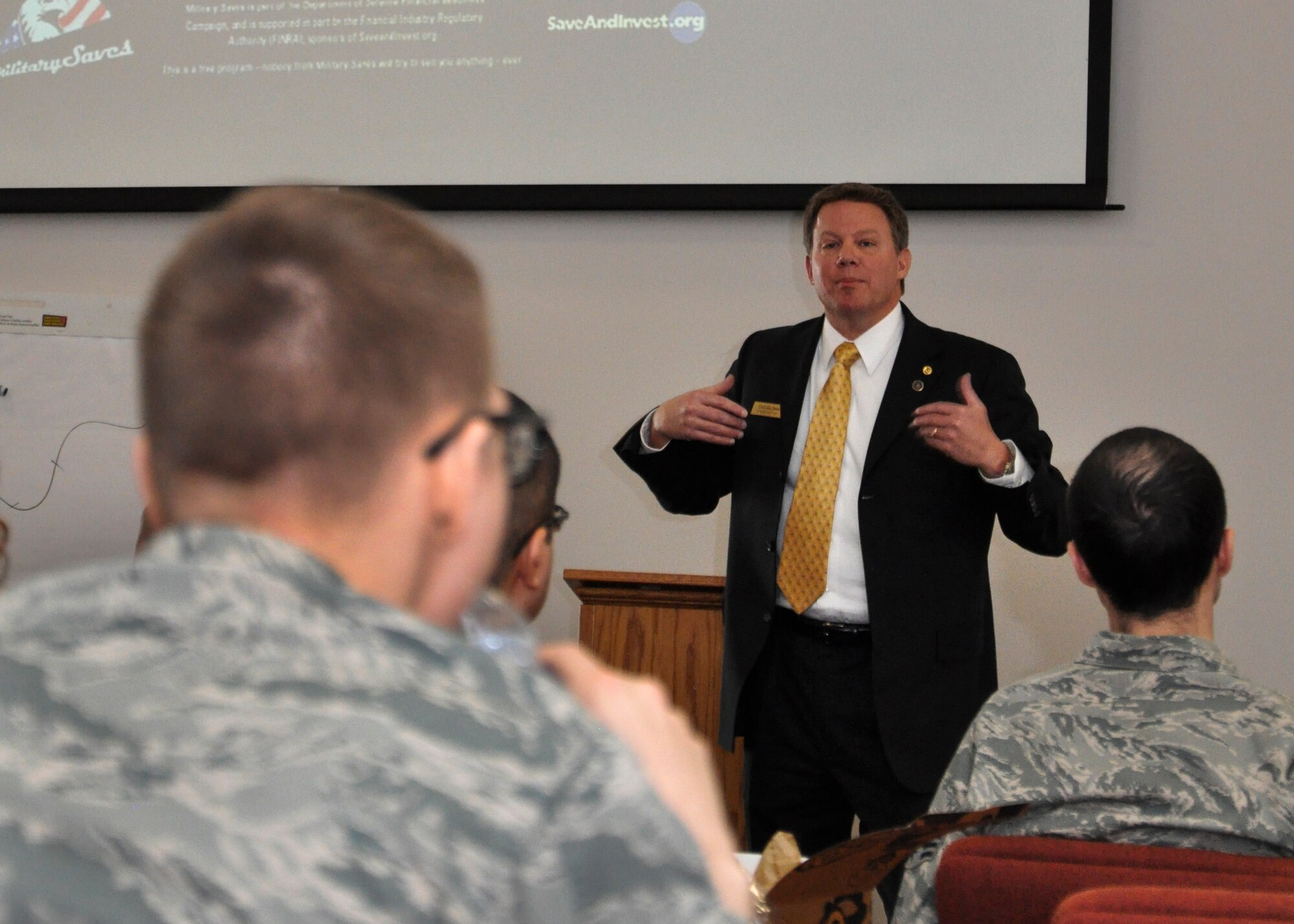 Todd Salzman, Ent Federal Credit Union military relationship manager, talks about the importance of saving from early on in life during the last briefing of a financial symposium March 1, 2013 at Bldg. 606, Buckley Air Force Base, Colo. The Buckley Airman and Family Readiness Center hosted a variety of financial events during their Military Saves Campaign from Feb. 25-March 1. (U.S. Air Force photo by Senior Airman Christopher Gross/Released)