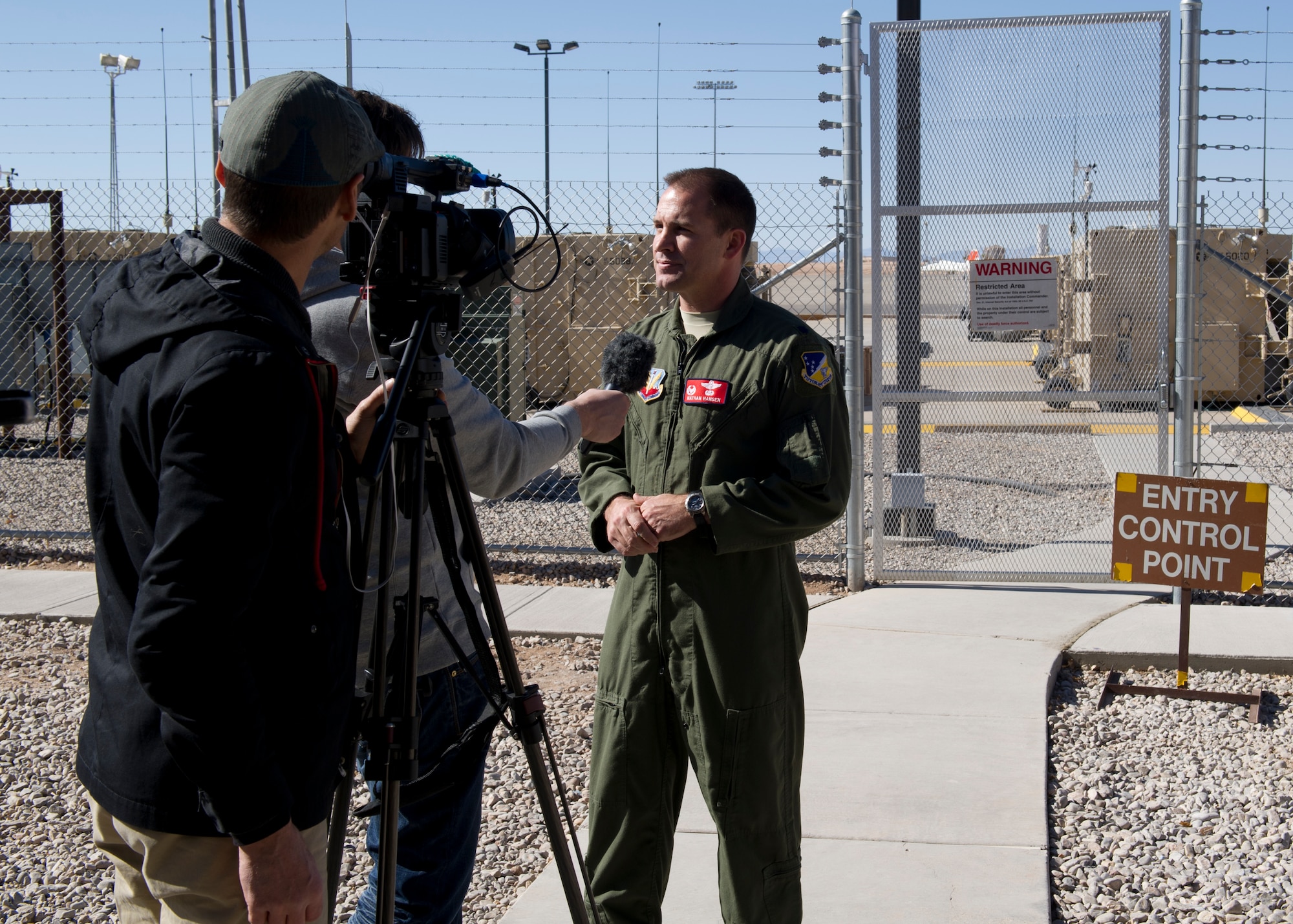 Lt. Col. Nathan Hansen, 29th Attack Squadron commander, answers questions from international media about the Remotely Piloted Aircraft Ground Control Stations during a media day at Holloman Air Force Base, N.M., Feb. 28. The MQ-1 Predators’ and MQ-9 Reapers’ capabilities make these aircraft uniquely qualified to conduct irregular warfare operations in support of Combatant Commander objectives. (U.S. Air Force photo by Senior Airman Kasey Close/Released)