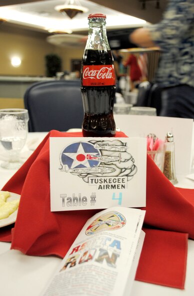 Small Coca Cola bottles were used as center pieces on the tables at a presentation on the Tuskegee Airmen on Feb. 26, 2013, at Grand Forks Air Force Base. N.D. The “Gladiators of the Sky” presentation was hosted by the African American Cultural Association in observance of this year’s African American/Black History Month. A soda bottle such as this one was given to a black pilot as a congratulatory prize for shooting down an enemy aircraft during WWII, while white pilots were typically given champagne. (U.S. Air Force photo/Staff Sgt. Luis Loza Gutierrez)