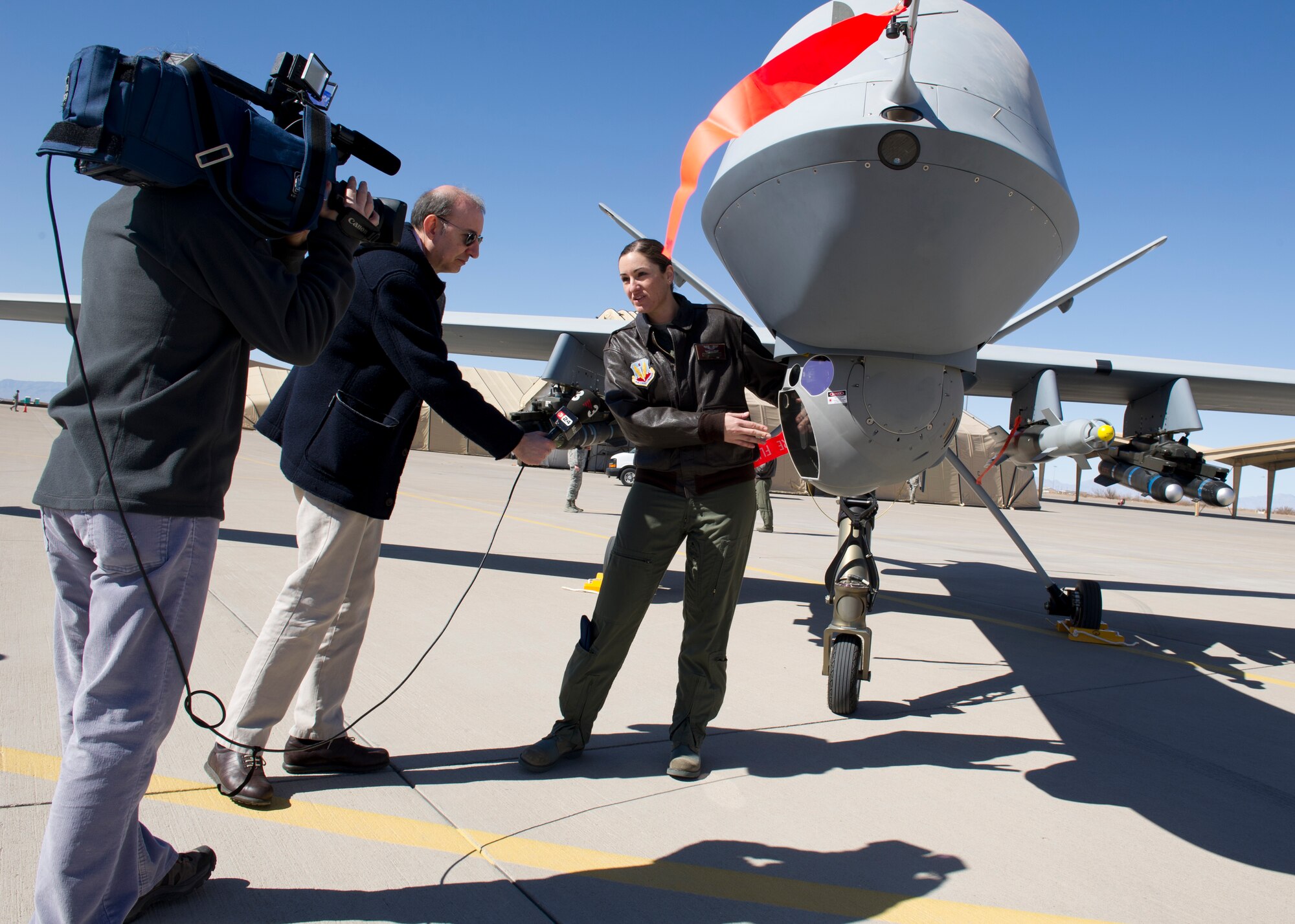 Tech. Sgt. Rachel (last name omitted due to operational security concerns), 29th Attack Squadron MQ-9 Reaper sensor operator instructor, explains the capabilities of the camera on the MQ-9 to international media during a media day at Holloman Air Force Base, N.M., Feb. 28. The MQ-9’s capabilities make it uniquely qualified to conduct irregular warfare operations in support of Combatant Commander objectives. (U.S. Air Force photo by Senior Airman Kasey Close/Released)