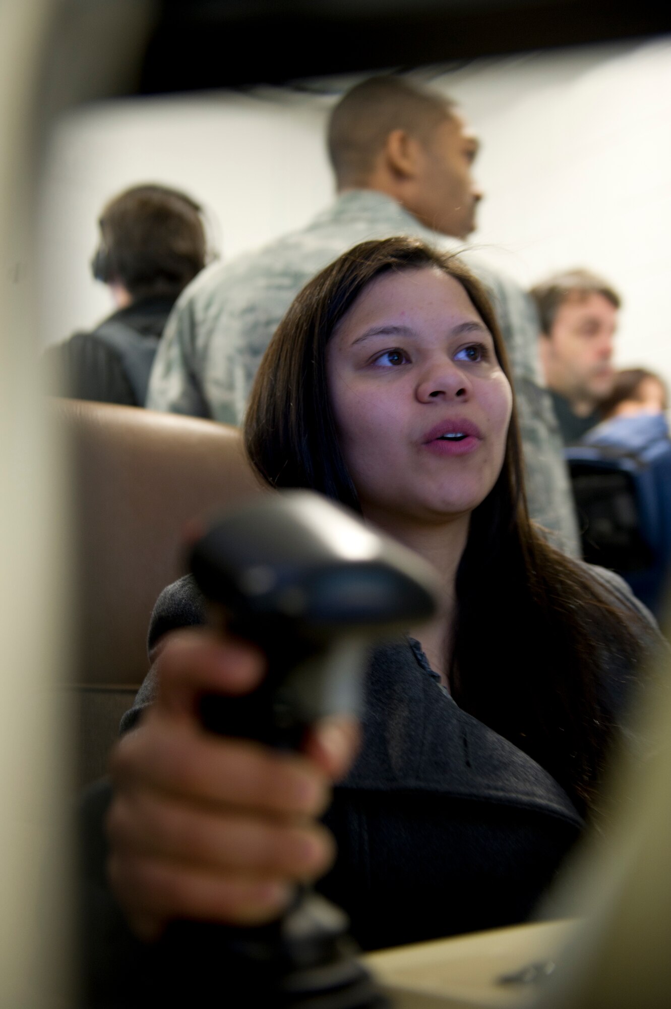 Janessa Maxilom, a reporter with the Alamogordo Daily News, sits at the controls of a MQ-9 Reaper simulator during a media day at Holloman Air Force Base, N.M., Feb. 28. The MQ-1's and MQ-9’s capabilities make these aircraft uniquely qualified to conduct irregular warfare operations in support of Combatant Commander objectives. (U.S. Air Force photo by Senior Airman Kasey Close/Released)