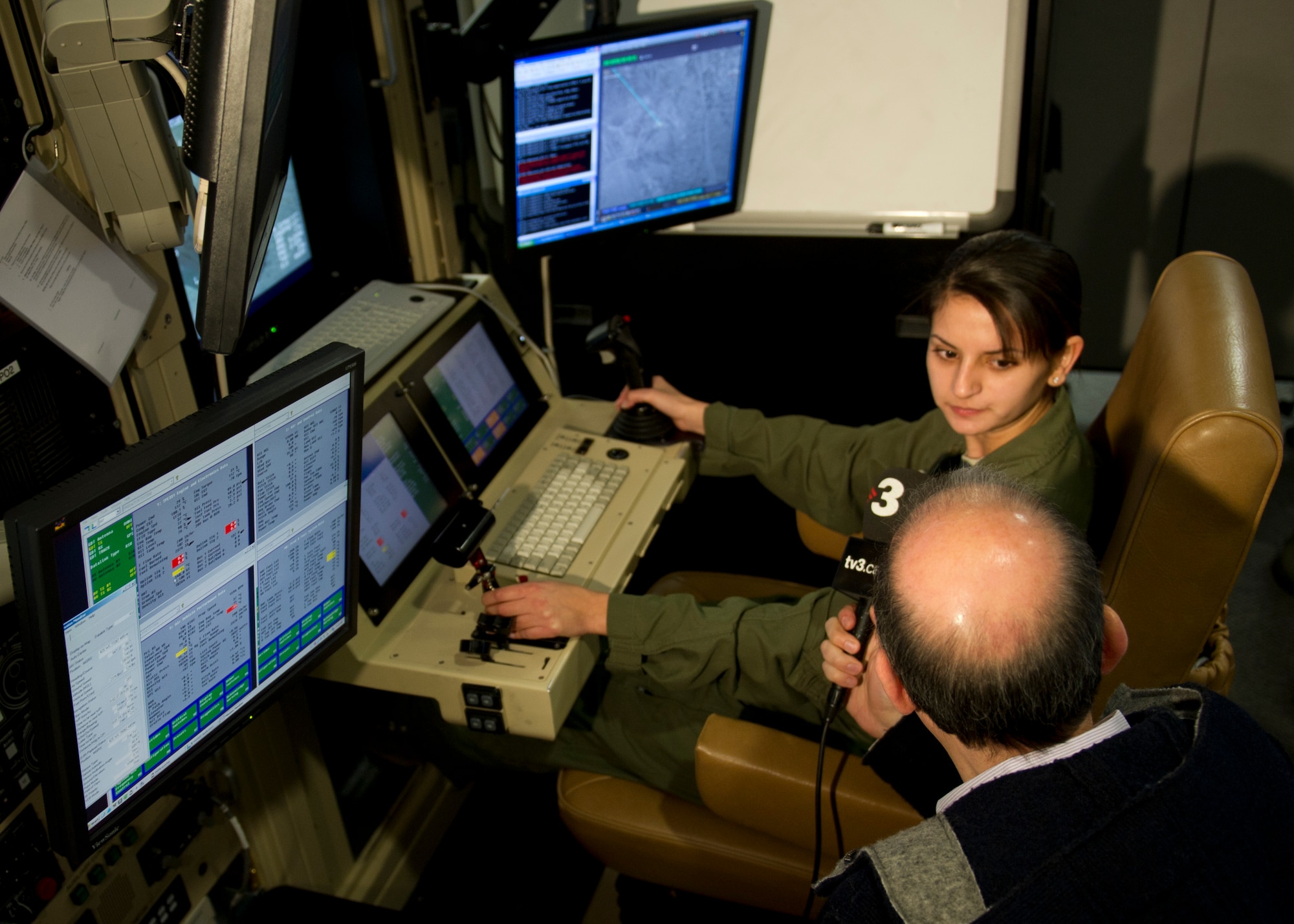 Senior Airman Gina (last name omitted due to operational security concerns), 9th Attack Squadron MQ-9 Reaper sensor operator instructor, talks to the media about the MQ-1 Predator and MQ-9 Reaper simulators during media day at Holloman Air Force Base, N.M., Feb. 28. Media days are scheduled once every quarter, with the next one tentatively scheduled for late June. (U.S. Air Force photo by Senior Airman Kasey Close/Released)