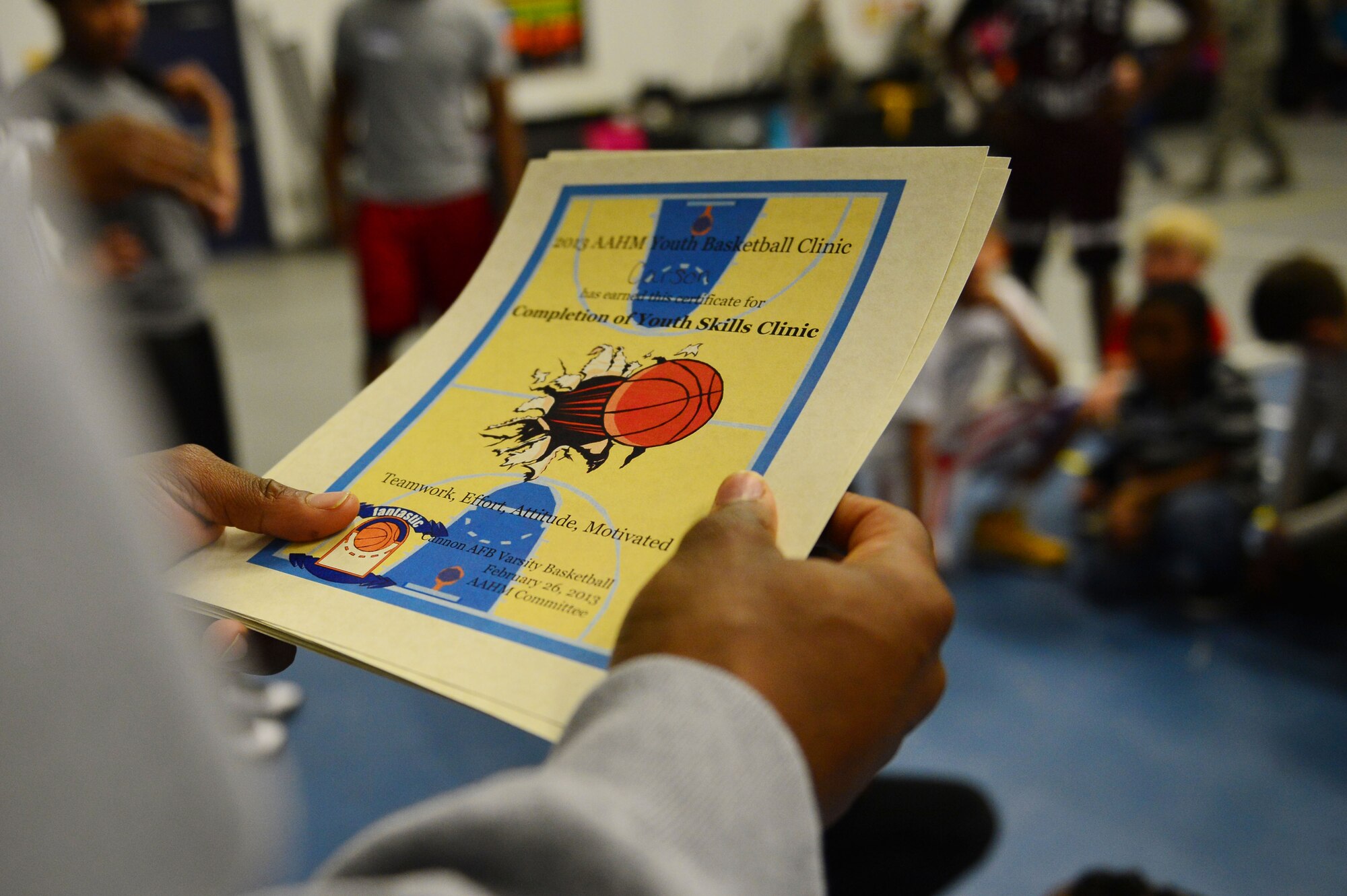 Each child recieved a certificate after partipating in a youth basketball clinic held in the Youth Center at Cannon Air Force Base, N.M., Feb. 26, 2013. Cannon's men's varsity basketball team hosted a youth basketball clinic for children, ages 6-11, to teach them standard fundamentals of the game. (U.S. Air Force photo/Airman 1st Class Eboni Reece)