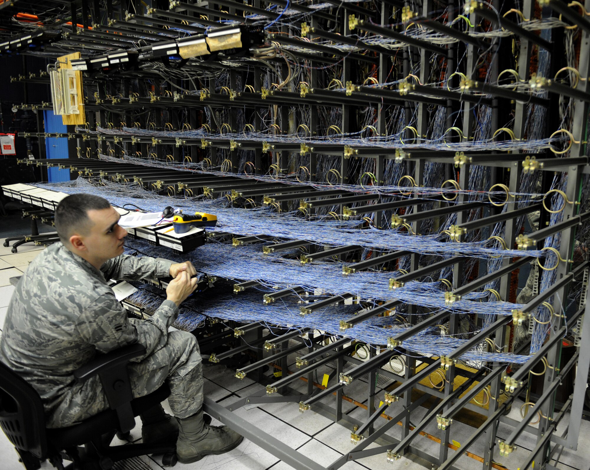 Airman 1st Class Dustin Lee, 2nd Communications Squadron cyber transport systems technician, searches for a wire on Barksdale Air Force Base, La., March 1. Airmen from the 2 CS were running cables to other buildings on base to ensure those buildings have telephone access. (U.S. Air Force photo/Airman 1st Class Benjamin Gonsier)
