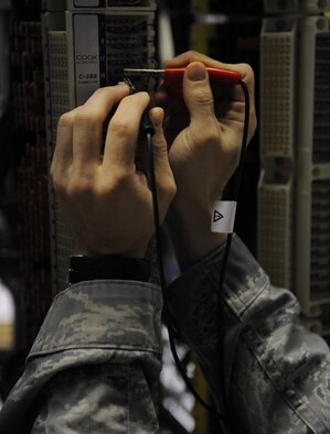 Senior Airman Gary Boston, 2nd Communications Squadron cable and antenna systems, checks for cable faults on Barksdale Air Force Base, La., March 1. Airmen from the 2 CS cable and antenna systems section repair and replace wiring and cables across the base and maintain the base's antennas, which are vital to communication. (U.S. Air Force photo/Airman 1st Class Benjamin Gonsier)