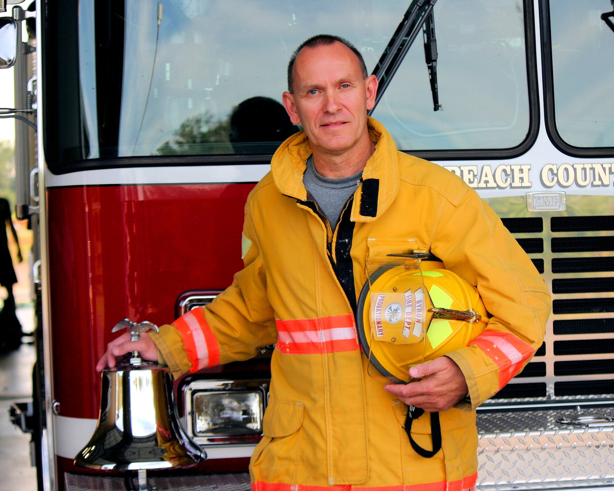 National Guard Master Sgt. Todd, from the 116th Air Control Wing (ACW), stands in front of a fire truck in Byron, Ga., Oct. 4, 2012.  Todd, a fulltime Guardsman with the 116th ACW, completed level-one fire fighter training to become a volunteer fire fighter in his community.(Contributed Photo/Released)  