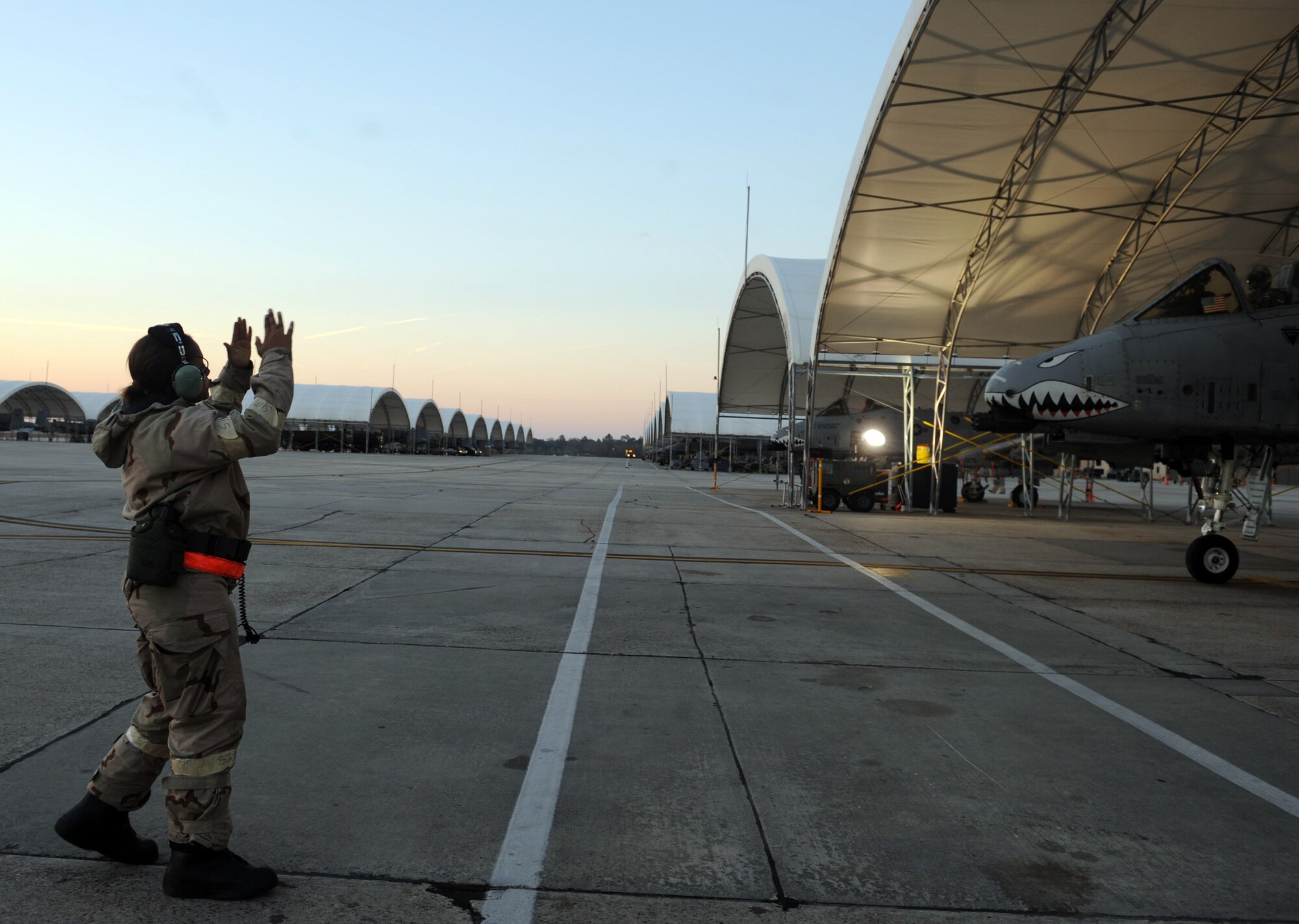 U.S. Air Force Senior Airman Takara Gedeon, 23d Aircraft Maintenance Squadron crew chief, signals Capt. Aaron Palan, 75th Fighter Squadron A-10C Thunderbolt II pilot, to begin taxiing toward the runway at Moody Air Force Base, Ga., Feb. 28, 2013. Crew chiefs keep constant communication with the pilot before takeoff to ensure the aircraft is functioning properly. (U.S. Air Force photo by Airman 1st Class Olivia Bumpers)