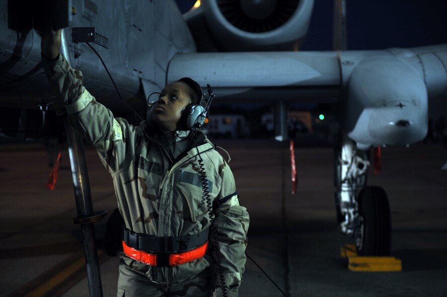 U.S. Air Force Senior Airman Takara Gedeon, 23d Aircraft Maintenance Squadron crew chief, performs routine checks on an A-10C Thunderbolt II at Moody Air Force Base, Ga., Feb. 28, 2013. Crew chiefs check the aircraft for any discrepancies before the pilot takes flight. (U.S. Air Force photo by Airman 1st Class Olivia Bumpers/Released)