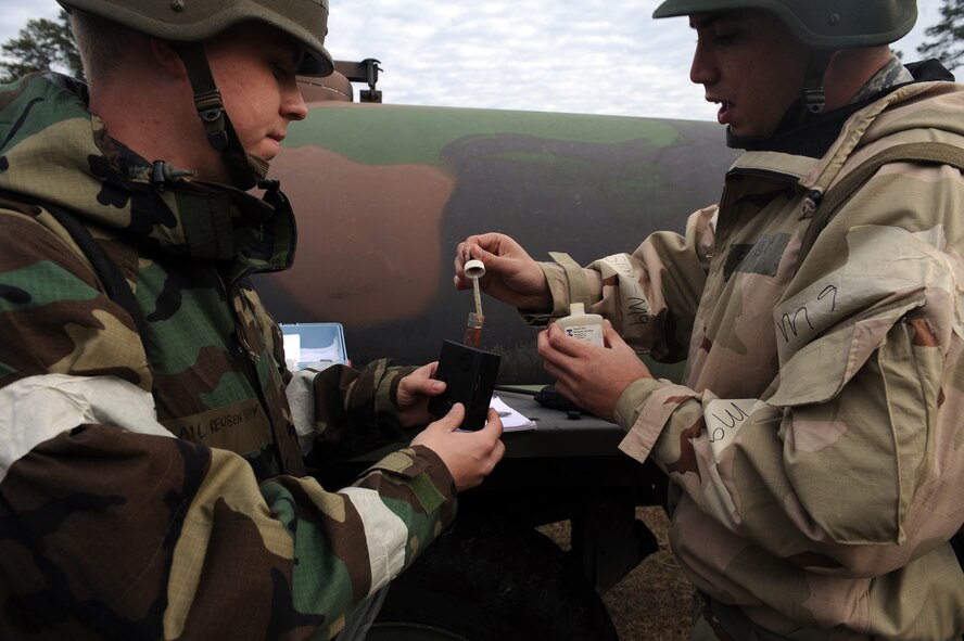 U.S. Air Force Senior Airman Robert Kost and Airman 1st Class Reuben Yancey, 23d Civil Engineer Squadron water and fuel maintainers, use a phenol red indicator in a water sample during an operational readiness exercise at Moody Air Force Base, Ga., Feb. 27, 2013. Phenol red is used to test the pH levels in the water. (U.S. Air Force photo by Airman 1st Class Olivia Bumpers/Released)