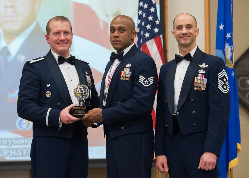 Staff Sgt. Breyson J. Robinson, 341st Mission Support Group, center, was named the 341st Missile Wing's Honor Guard Member of the Year for 2012.  Shown presenting the award are Col. Robert W. Stanley II, 341 MW commander, and Chief Master Sgt. Frank V. Fidani, 341 MW command chief.  The presentation was made at the Wing Quarterly Awards Banquet held Feb. 22 at the Grizzly Bend.  (U.S. Air Force photo/ Beau Wade)