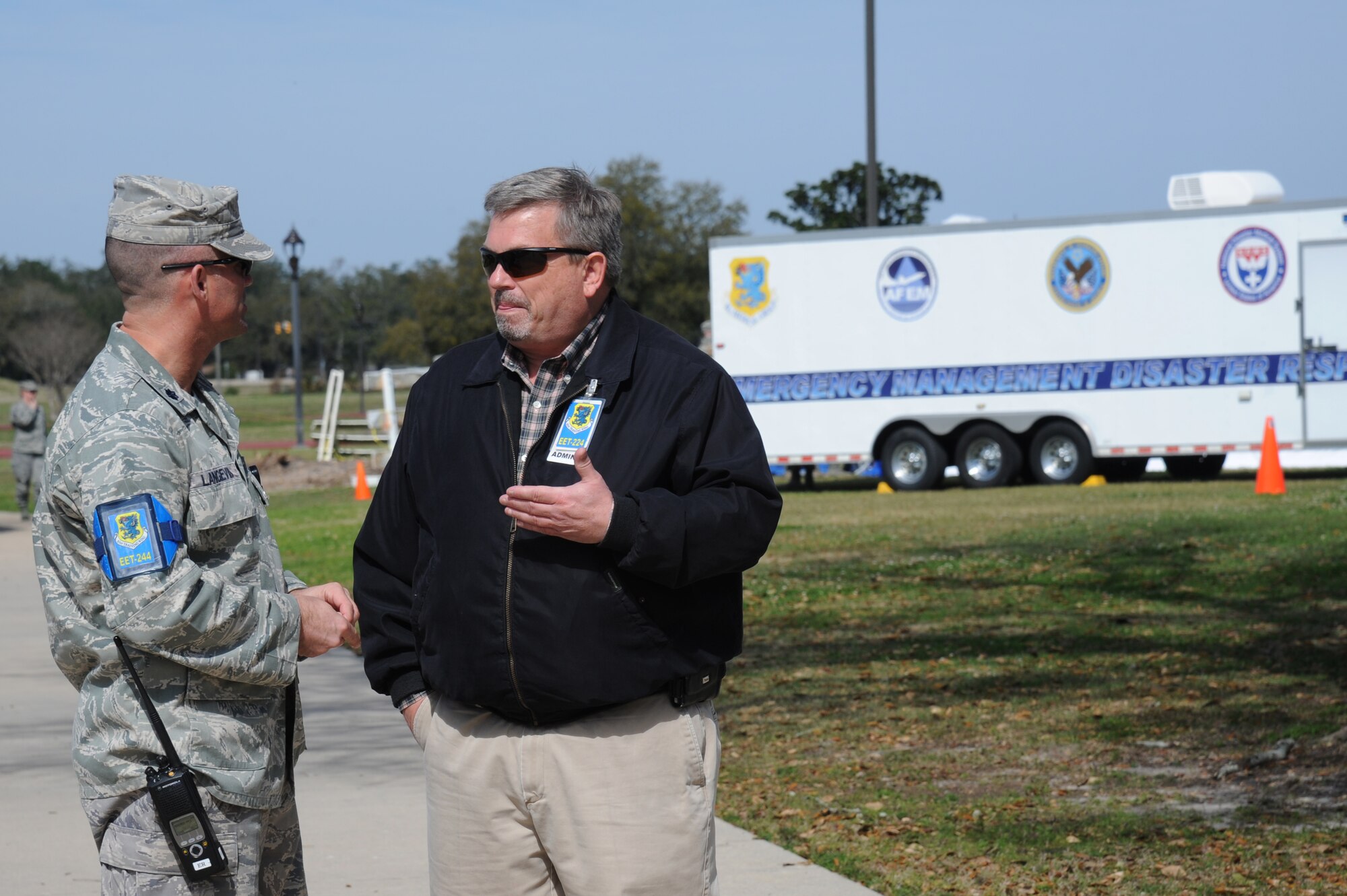 Lt. Col. Paul Langevin, 81st Medical Operations Squadron, and Bob Tash, 81st Medical Support Squadron, discuss the progress of the exercise as exercise evaluation team members during a disease containment plan and point of dispensing exercise Feb. 28, 2013, near the Vandenburg Community Center, Keesler Air Force Base, Miss.  The scenario included a series of biological attacks in which numerous Keesler personnel became infected and the medical group had to distribute large quantities of medicine to efficiently minimize risk. (U.S. Air Force photo by Kemberly Groue)
