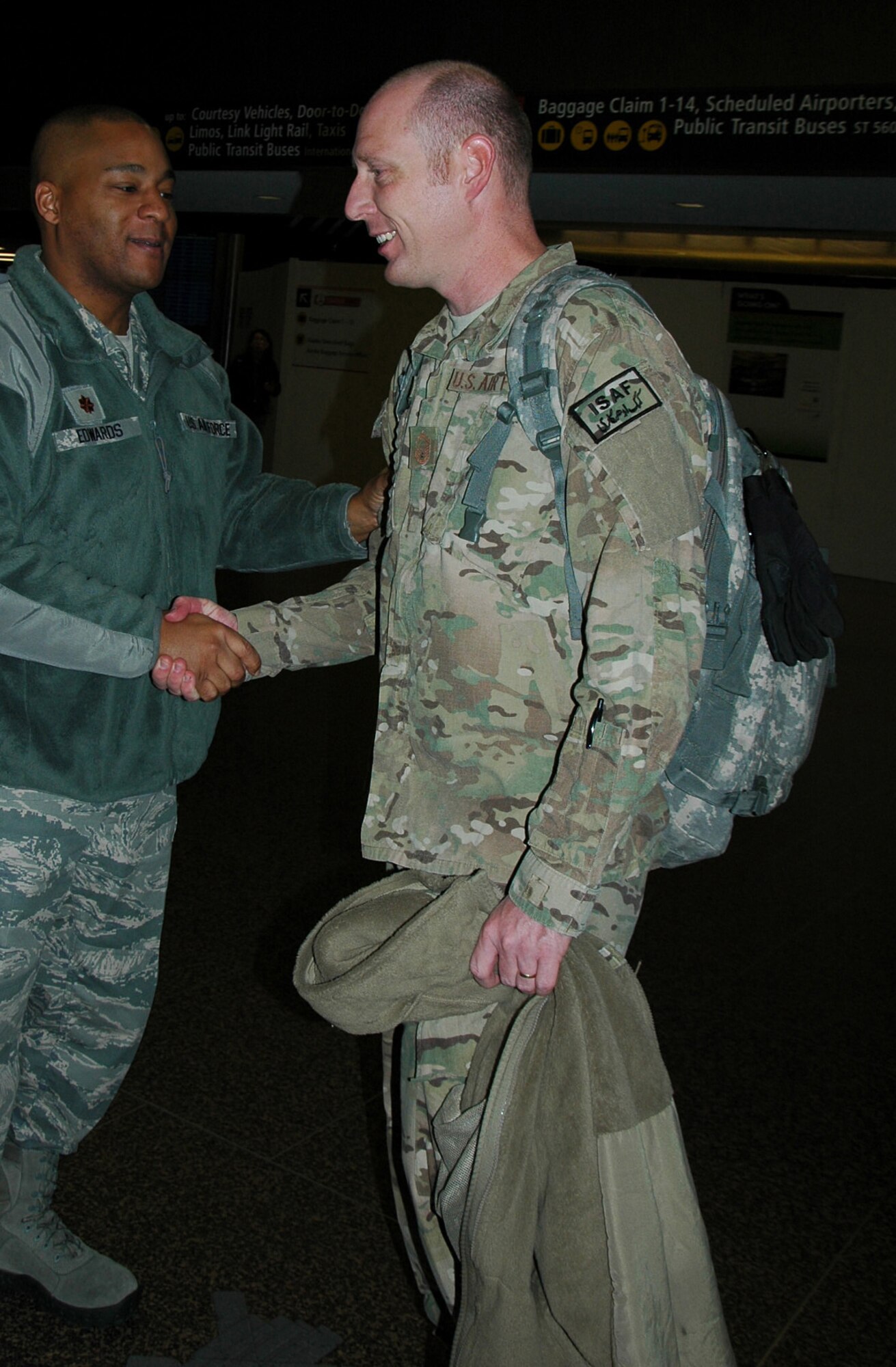 Maj. Tony Edwards, left, commander of the 86th Aerial Port Squadron, welcomes home Senior Master Sgt. Marshall Stokoe. Stokoe was one of 13 Reserve 86th APS Airmen who returned from Afghanistan Feb. 28. (U.S. Air Force photo by Sandra Pishner)