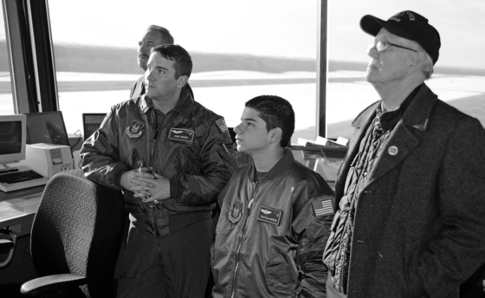 Tristan Morse, center, the Patriot Wing’s Pilot for A Day, gets a tour
of the Westover Tower and a view of aircraft traffic in the area on one of the monitors.
(photo by SrA. Alexander Brown)