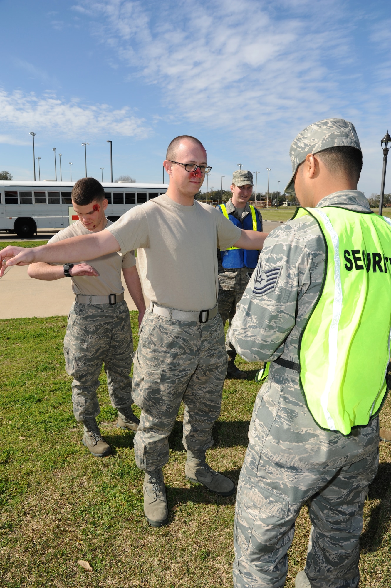 Airman Basic Dominic Lycke, 336th Training Squadron, portrays a “victim” of anthrax exposure who is being processed through security by Tech. Sgt. Mark Bautista, 81st Medical Operations Squadron, prior to him entering a medical tent where he will receive treatment during a disease containment plan/point of dispensing exercise Feb. 28, 2013, near the Vandenburg Community Center, Keesler Air Force Base, Miss.  The scenario included a series of biological attacks in which numerous Keesler personnel became infected and the medical group had to distribute large quantities of medicine to efficiently minimize risk.  (U.S. Air Force photo by Kemberly Groue)