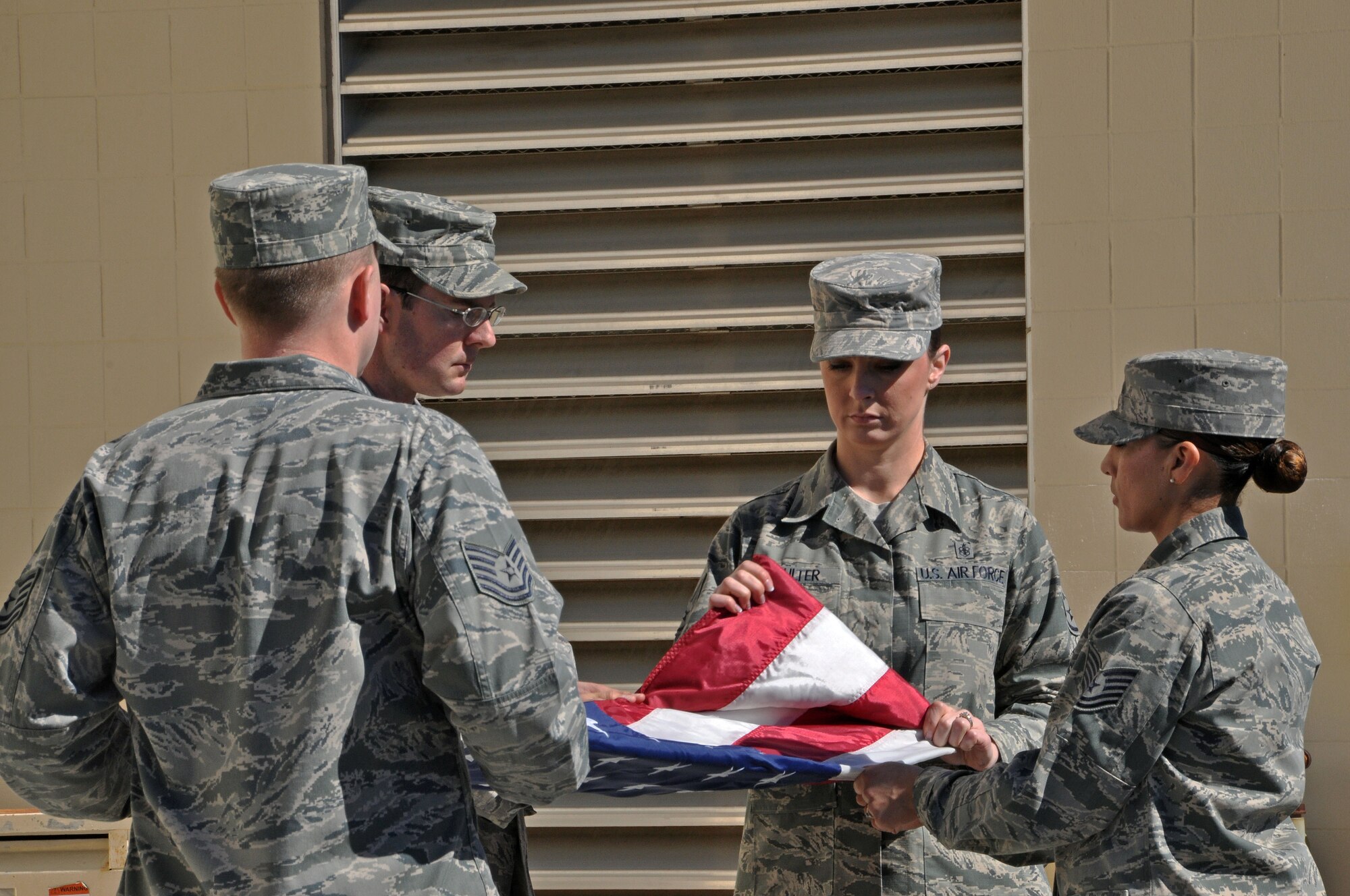 The flag detail consists of instructors from the Airman Leadership School on Travis Air Force Base.  The instructors demonstrate the flag ceremony to the honorary commanders while they render the appropriate customs and courtesies during the honorary commander boot camp Feb. 21. (U.S. Air Force photo/Airman 1st Class Madelyn Brown).