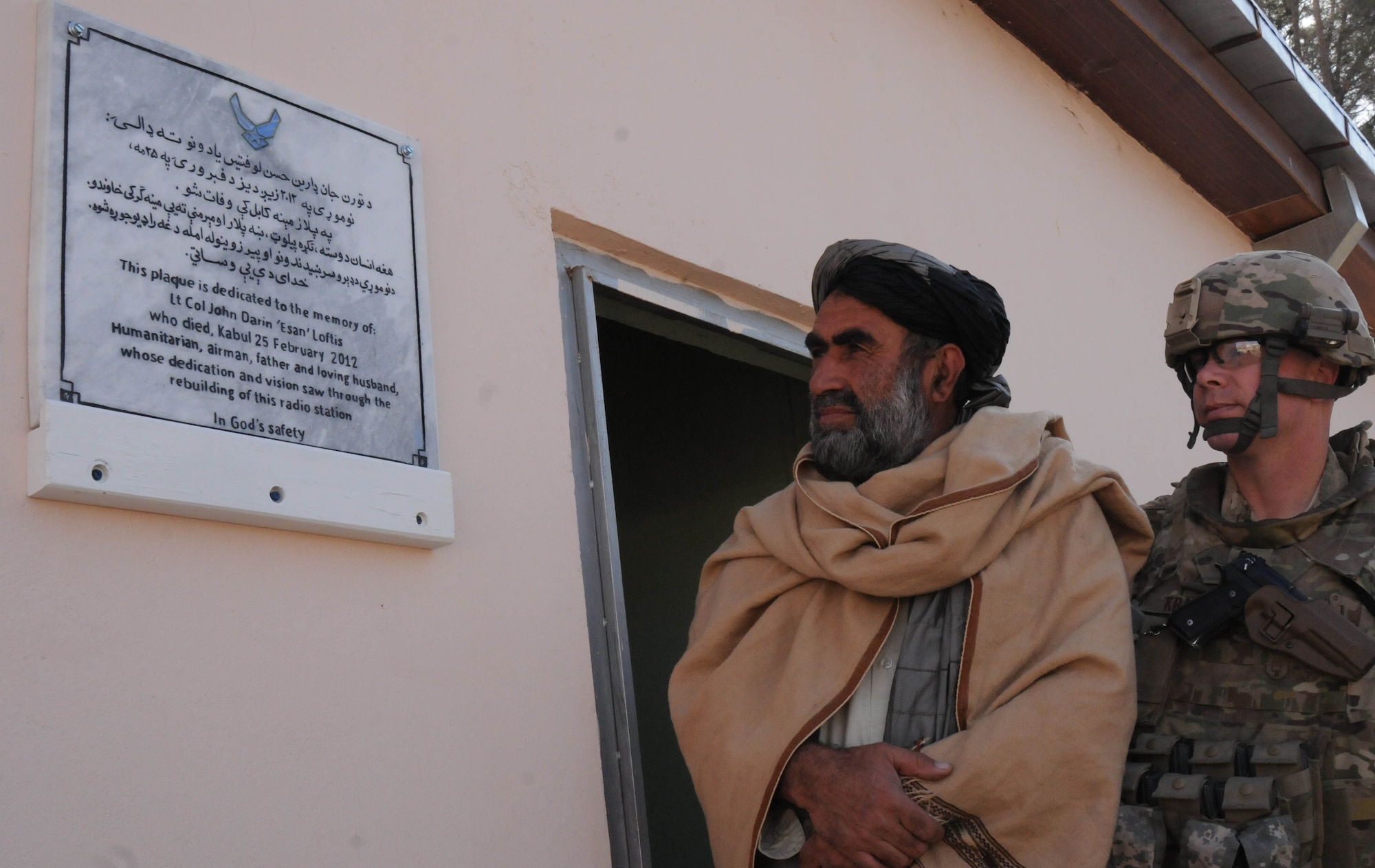U.S. Air Force Lt. Col. Justin Kraft, commander of the Zabul Provincial Reconstruction Team, and Bismullah Lodin, a radio station official, read the plaque dedicated in memory U.S. Air Force Lt. Col. John Darin Loftis, who died Feb. 25, 2012 from wounds received during an attack in Kabul. Loftis was a former member of Z PRT and instrumental in the development of the new radio station in Zabul Province. Members of Z PRT, along with radio station officials dedicated the radio station in his memory Jan. 17. (U.S. Air Force Photo by Staff Sgt. Patrice Clarke)
