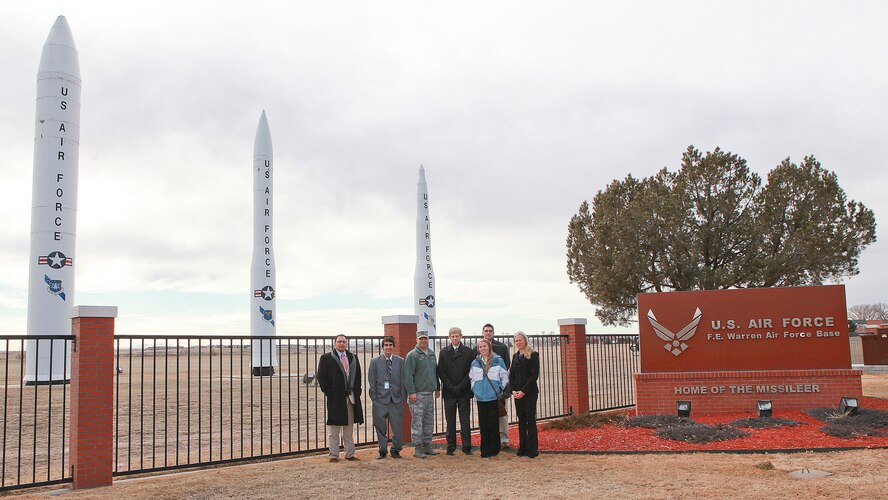 Col. George Farfour, 90th Missile Wing vice commander; Darrin Munoz, military liaison to Senator Mike Enzi; Daniel Gallegos, military liason to Senator John Barrasso; and Michael Trujillo, Brandi Haupt, Christopher Perry and Rebekah Forman, all interns for the senators, pose for a photograph in front of the displayed missiles near Gate 1 during their visit to F. E. Warren Air Force Base Feb. 19. (U.S. Air Force photo by Matt Bilden)