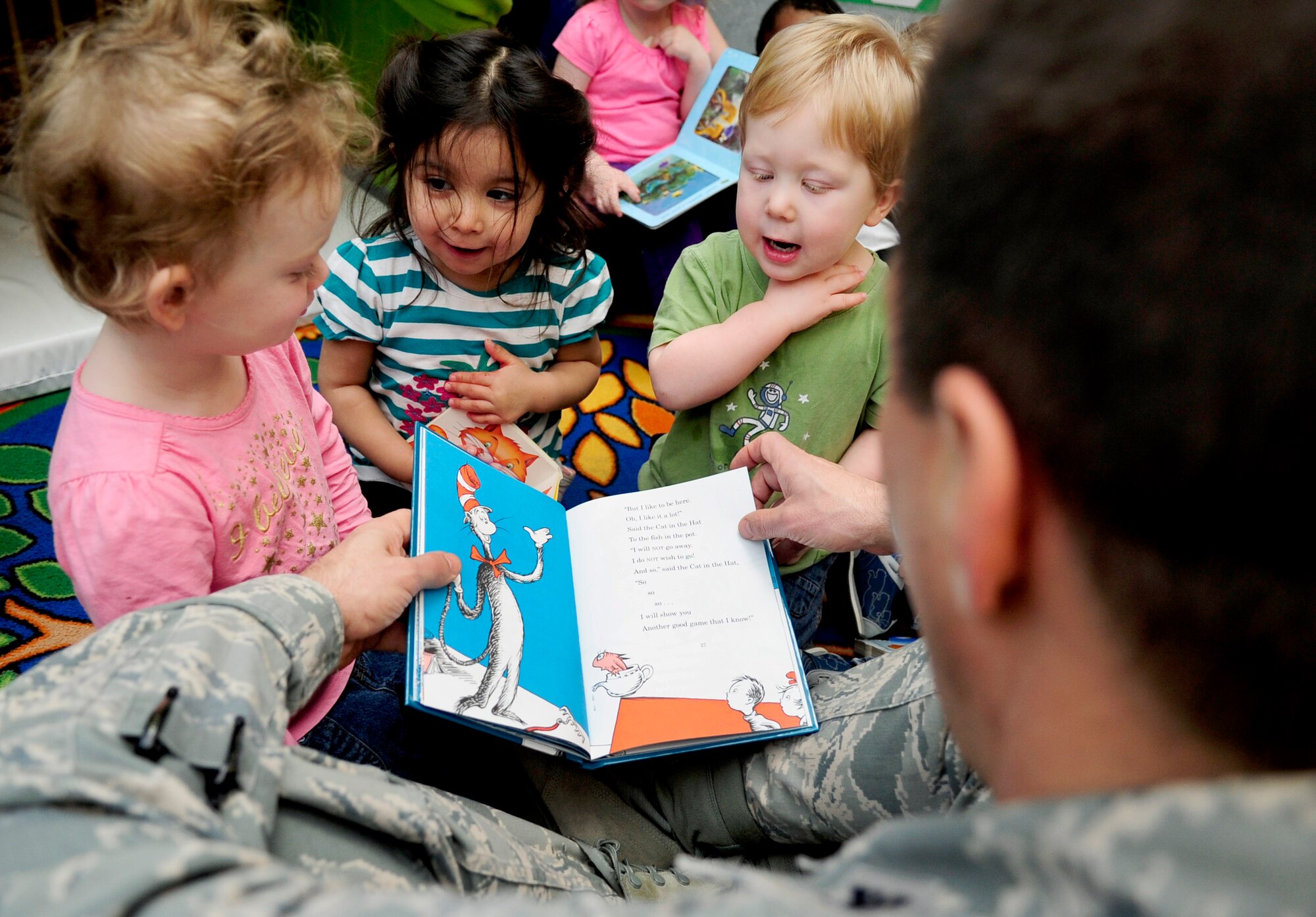 Kailyn Austin, 2, Saige Yee-Flores, 2, and Ethan Montgomery, 2, listen as Col. Christopher Kulas, 100th Air Refueling Wing commander, reads Dr.
Seuss' "Cat in the Hat" to them March 1, 2013, at the child development center on RAF Mildenhall, England.  March 1 is Read Across America Day, which is a
nationwide observance coinciding with the birthday of Dr. Seuss Geisel, the author of many popular children's books.  In 1997, the National Education
Association pushed for a special day to celebrate reading throughout the United States. This idea proved to be a popular one; the first Read Across
America Day was held March 2, 1998. (U.S. Air Force photo by Senior Airman Ethan Morgan/Released)
