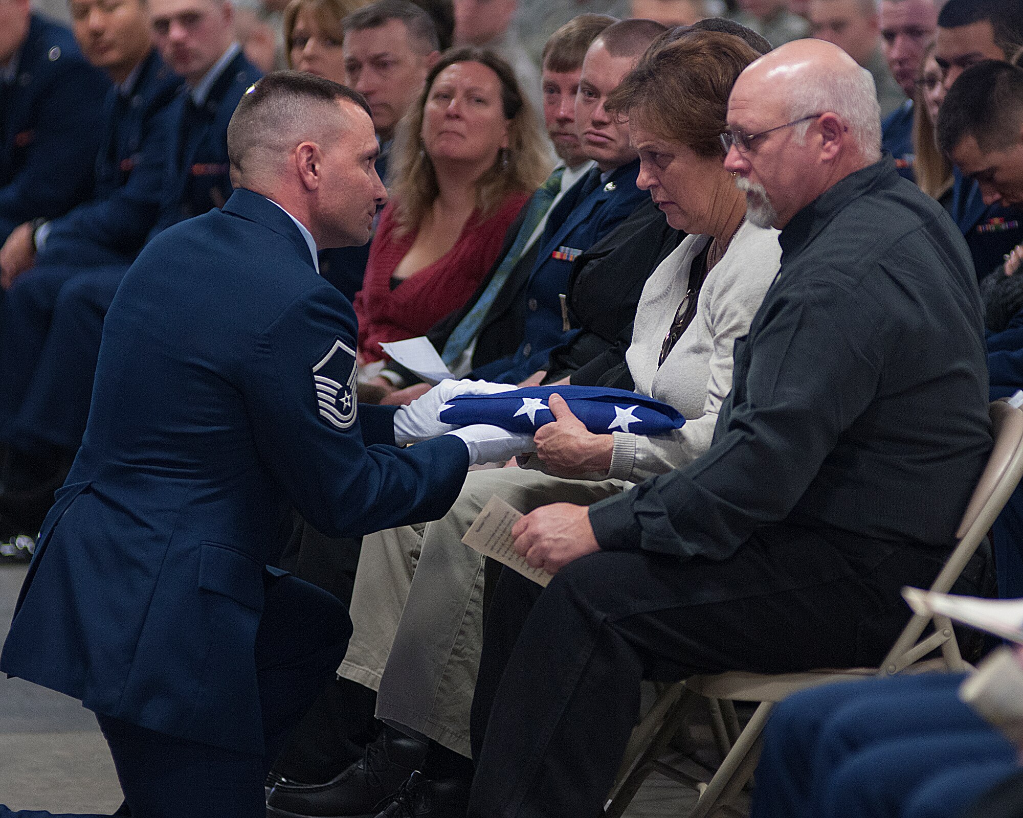 Master Sgt. James Fultz, 90th Maintenance Operations Squadron, presents Senior Airman Robert Neil’s mother, Jeanne Neil, the folded flag at Neil’s memorial service on F. E. Warren Air Force Base, Wyo., Feb. 21. Neil died Feb. 18 following an automobile accident in Cheyenne, Wyo. (U.S. Air Force Photo by R.J. Oriez)