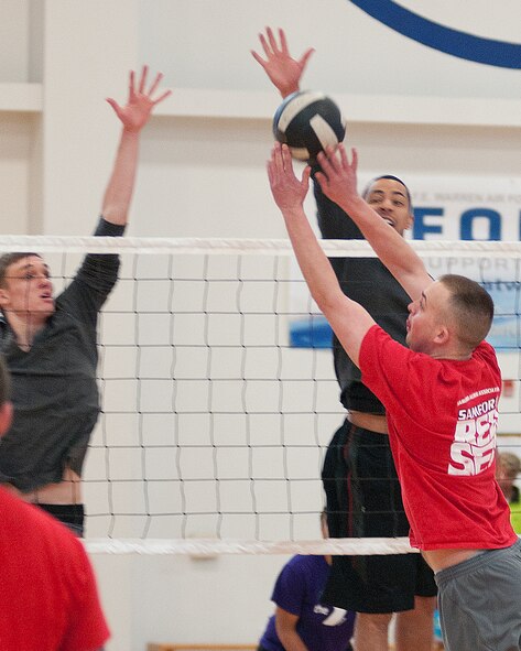 The 90th Missile Maintenance Group’s Jeff Grossi, left, and Corey Rucker go up to block 90th Comptroller Squadron’s Ryan England’s shot during a volleyball tournament at Freedom Hall Fitness Center on F. E. Warren Air Force Base Feb. 23. The 90th MXG went on to win the three-team, double elimination tournament by defeating the 90th CPTS twice. (U.S. Air Force photo by R.J. Oriez)