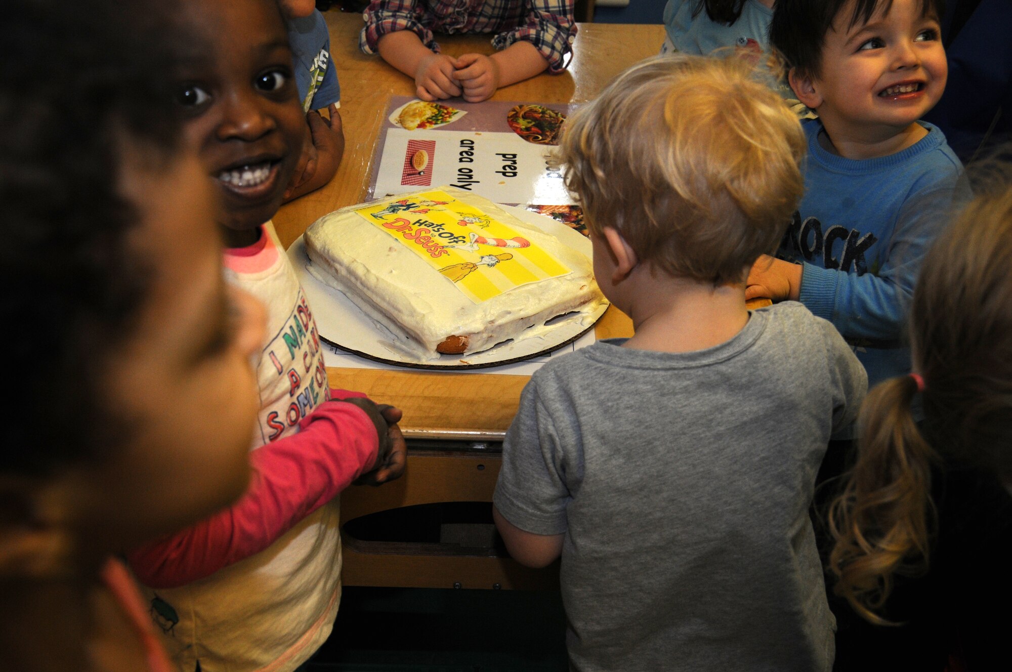 Children enjoy cake to celebrate the birthday of Dr. Seuss March 1, 2013, at the child development center on RAF Mildenhall, England. March 1 is Read Across America Day, which is a nationwide observance coinciding with the birthday of Dr. Seuss Geisel, the author of many popular children's books. In 1997, the National Education Association pushed for a special day to celebrate reading throughout the United States. This idea proved to be a popular one; the first Read Across America Day was held March 2, 1998. (U.S. Air Force photo by Gina Randall/Released)