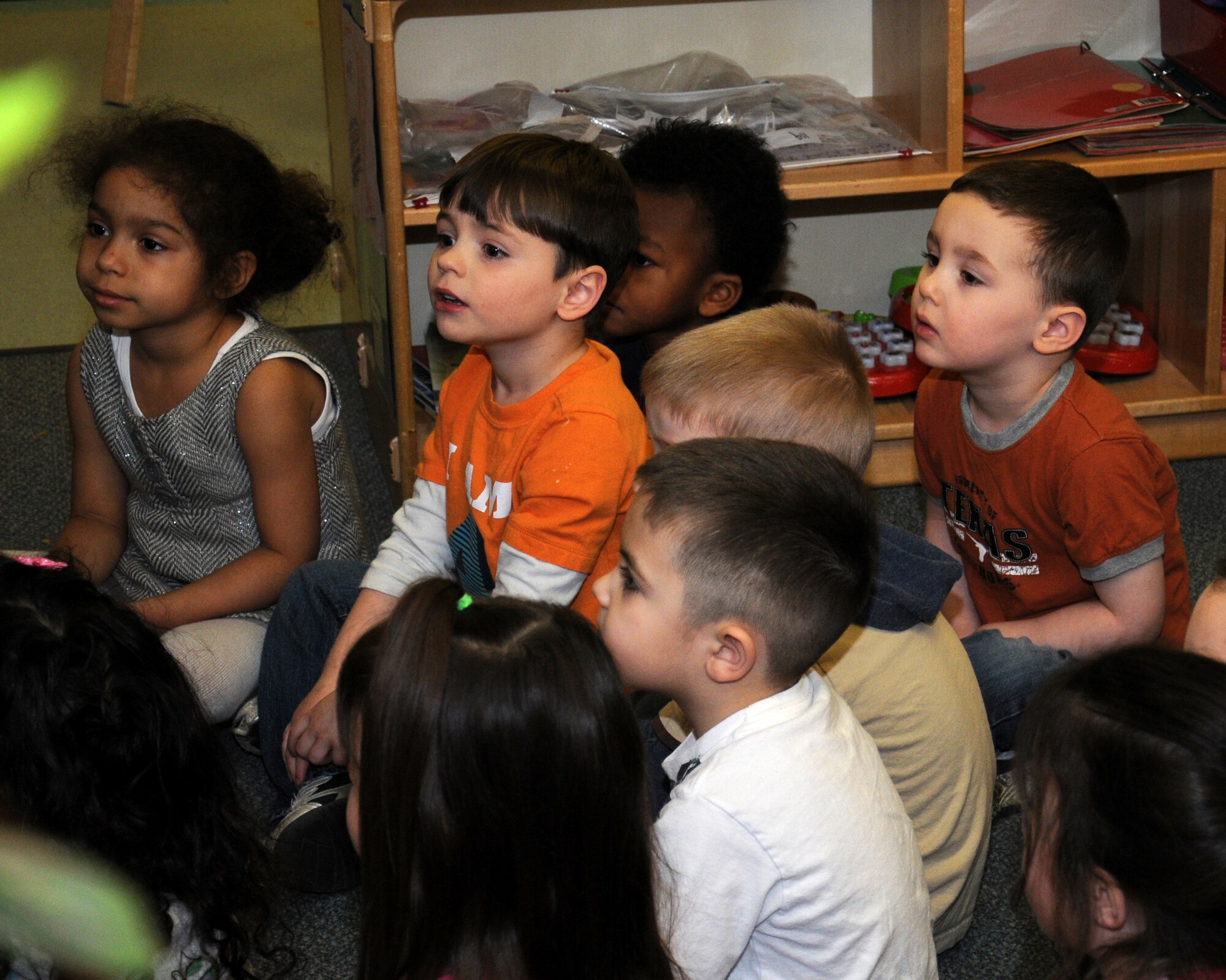 Col. Kyle Voigt, 100th Air Refueling Wing vice commander, reads a Dr. Seuss' book to children March 1, 2013, at the child development center on RAF Mildenhall, England. March 1 is Read Across America Day, which is a nationwide observance coinciding with the birthday of Dr. Seuss Geisel, the author of many popular children's books. In 1997, the National Education Association pushed for a special day to celebrate reading throughout the United States. This idea proved to be a popular one; the first Read Across America Day was held March 2, 1998. (U.S. Air Force photo by Gina Randall/Released)